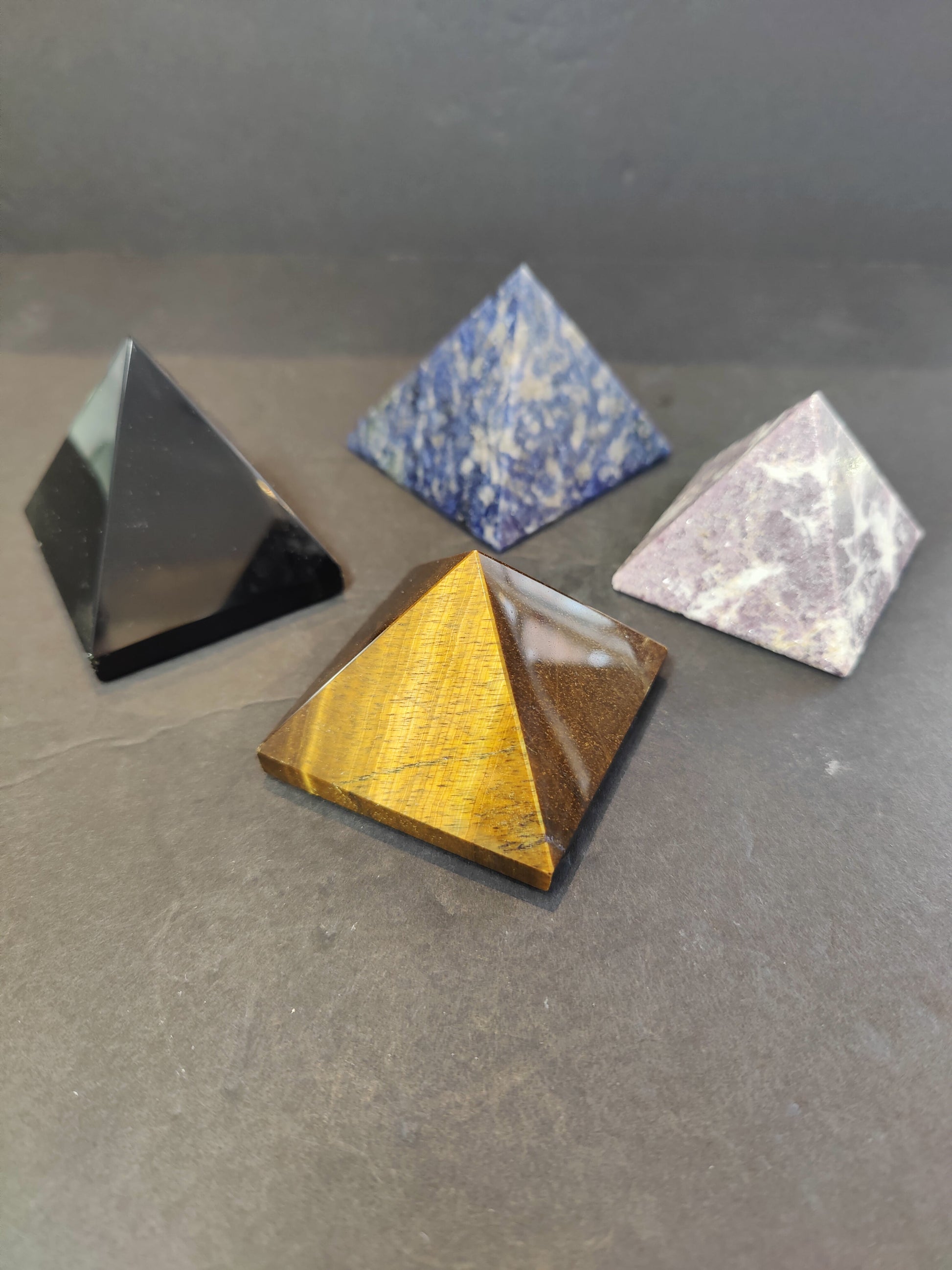 Polished crystal pyramid sculptures in assorted stones including amethyst, tiger eye, black obsidian and rose quartz — view 3