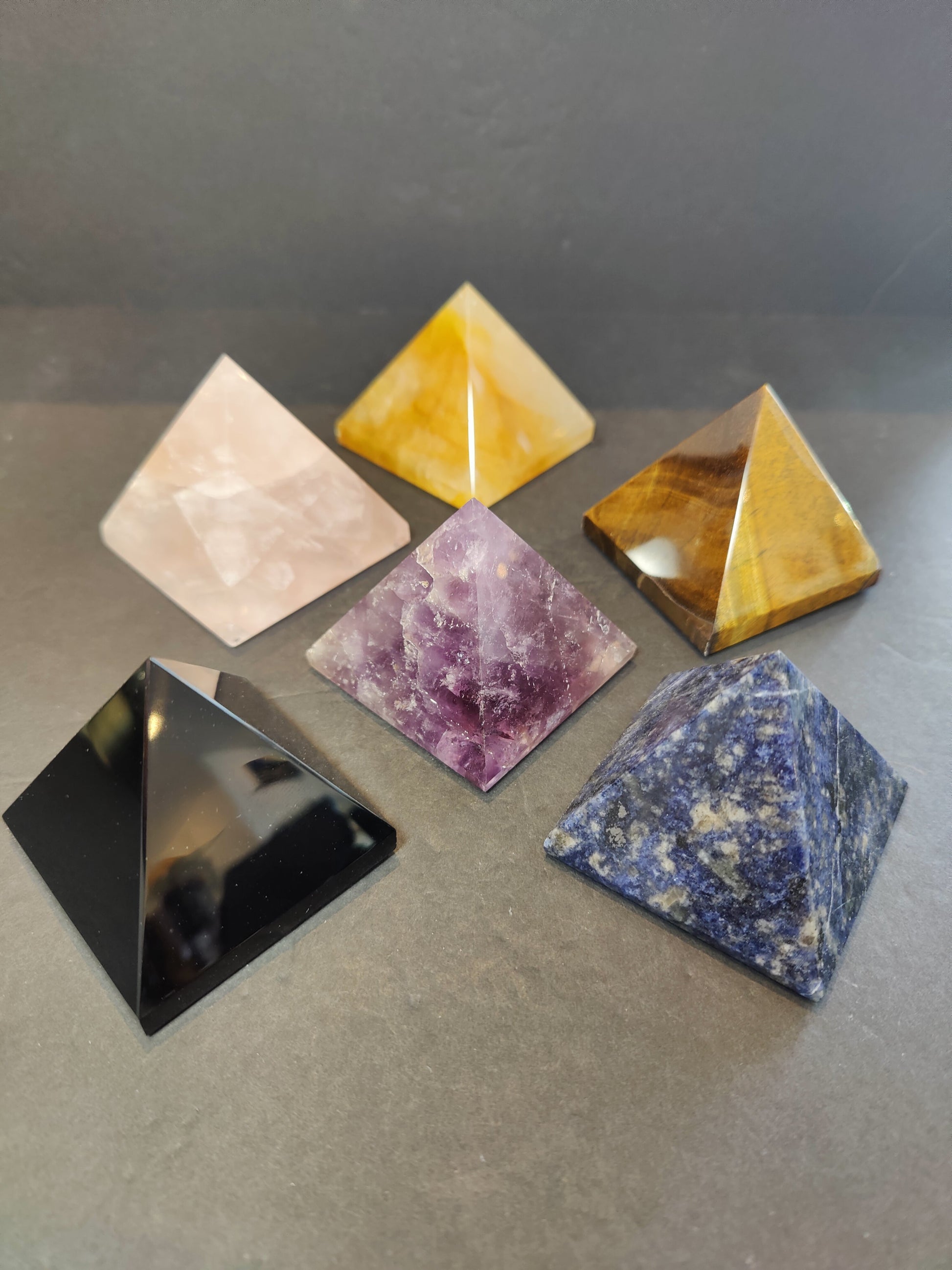Polished crystal pyramid sculptures in assorted stones including amethyst, tiger eye, black obsidian and rose quartz — view 4
