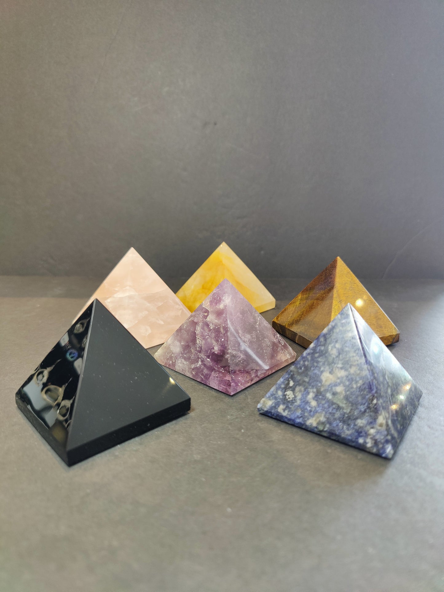 Polished crystal pyramid sculptures in assorted stones including amethyst, tiger eye, black obsidian and rose quartz — view 5