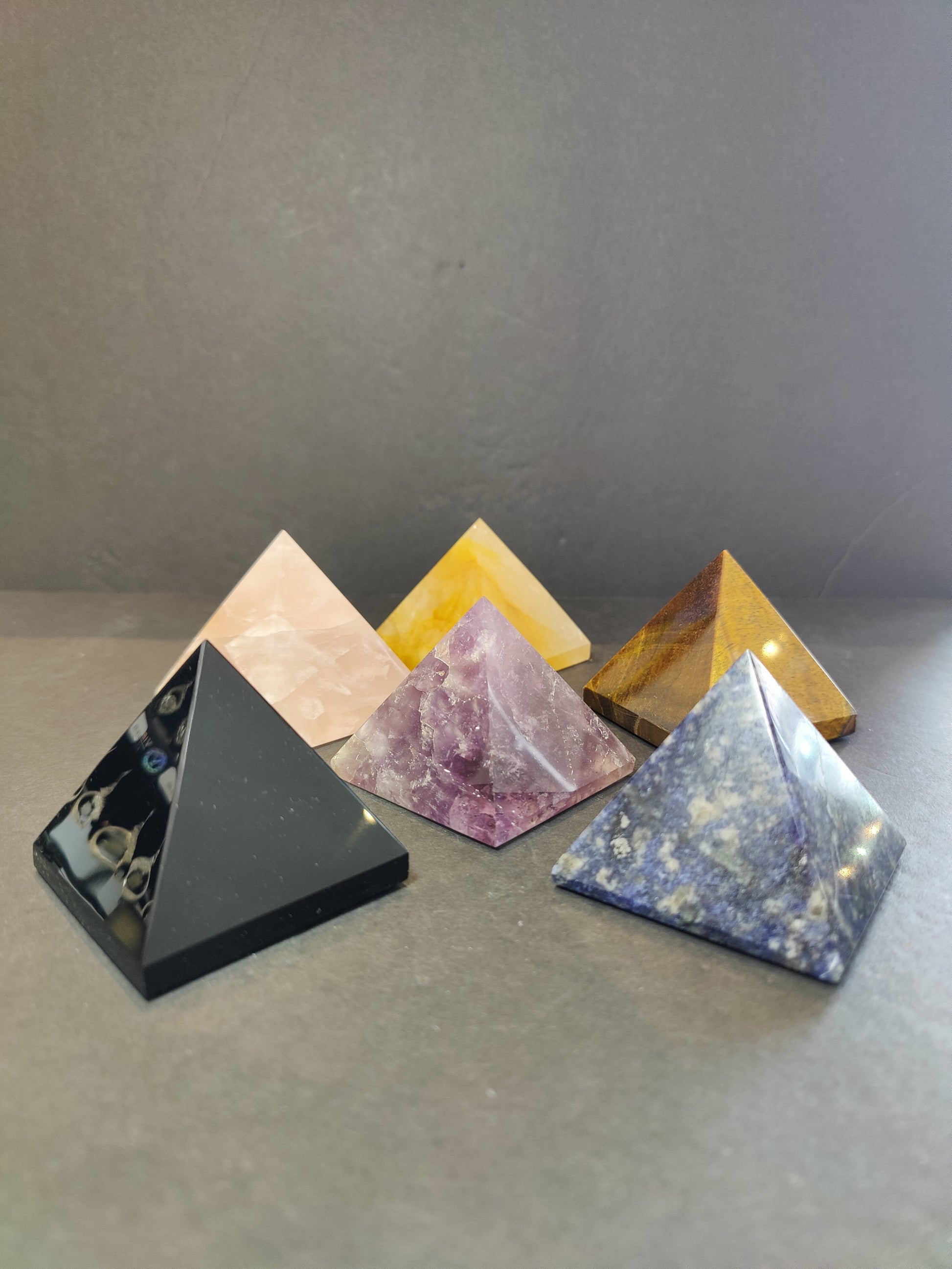 Polished crystal pyramid sculptures in assorted stones including amethyst, tiger eye, black obsidian and rose quartz — view 5
