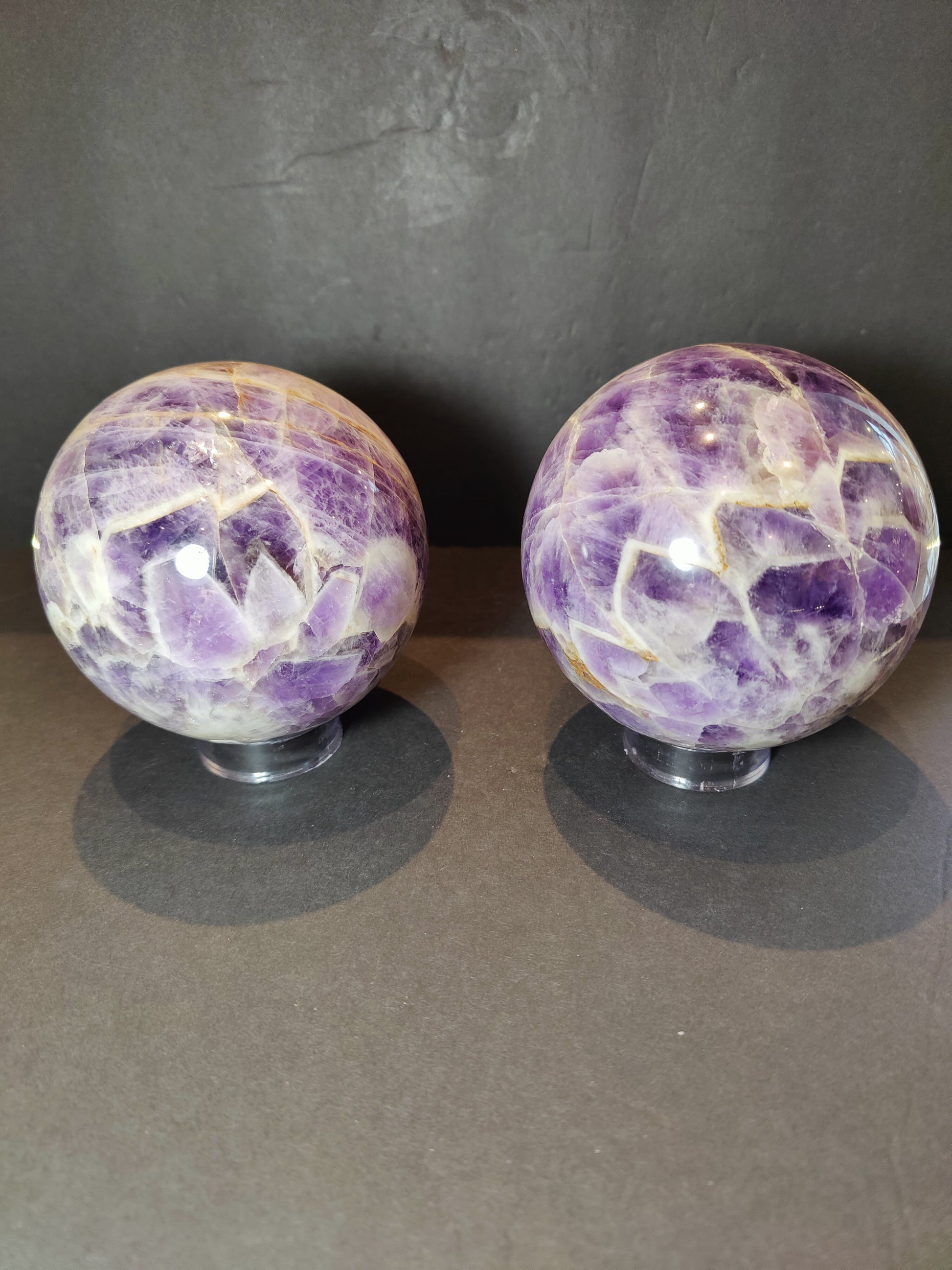 Polished chevron amethyst sphere with V-shaped bands of purple and white quartz — view 2