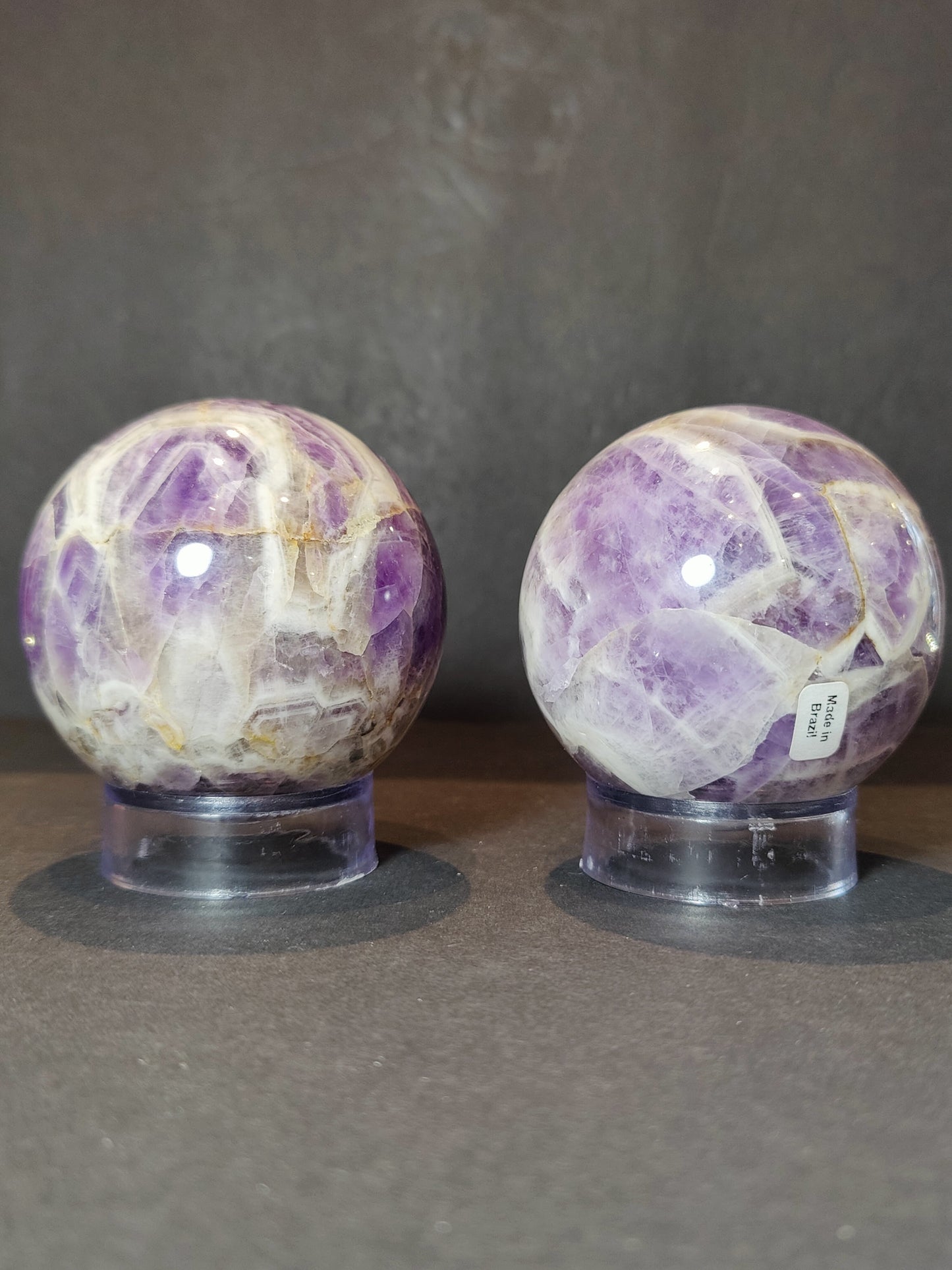 Polished chevron amethyst sphere with V-shaped bands of purple and white quartz — view 3