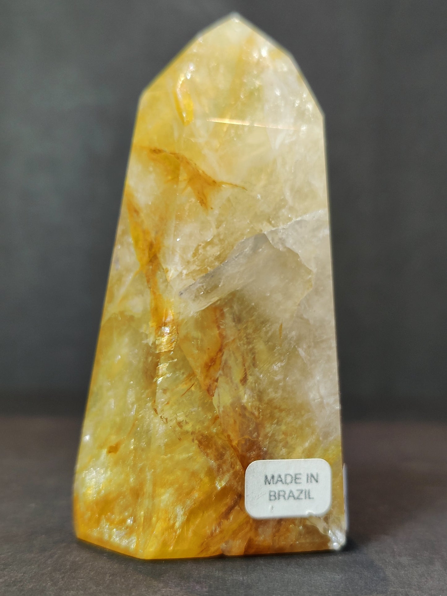 Side view of the polished Golden Healer Hematoid Quartz Obelisk Tower showing its colour and inclusions