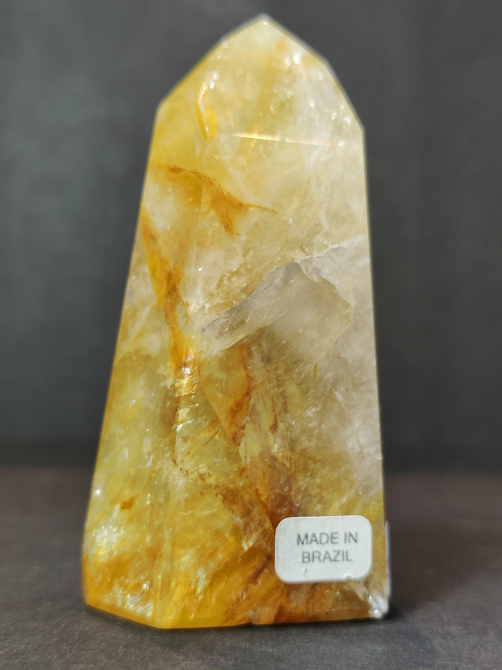 Side view of the polished Golden Healer Hematoid Quartz Obelisk Tower showing its colour and inclusions