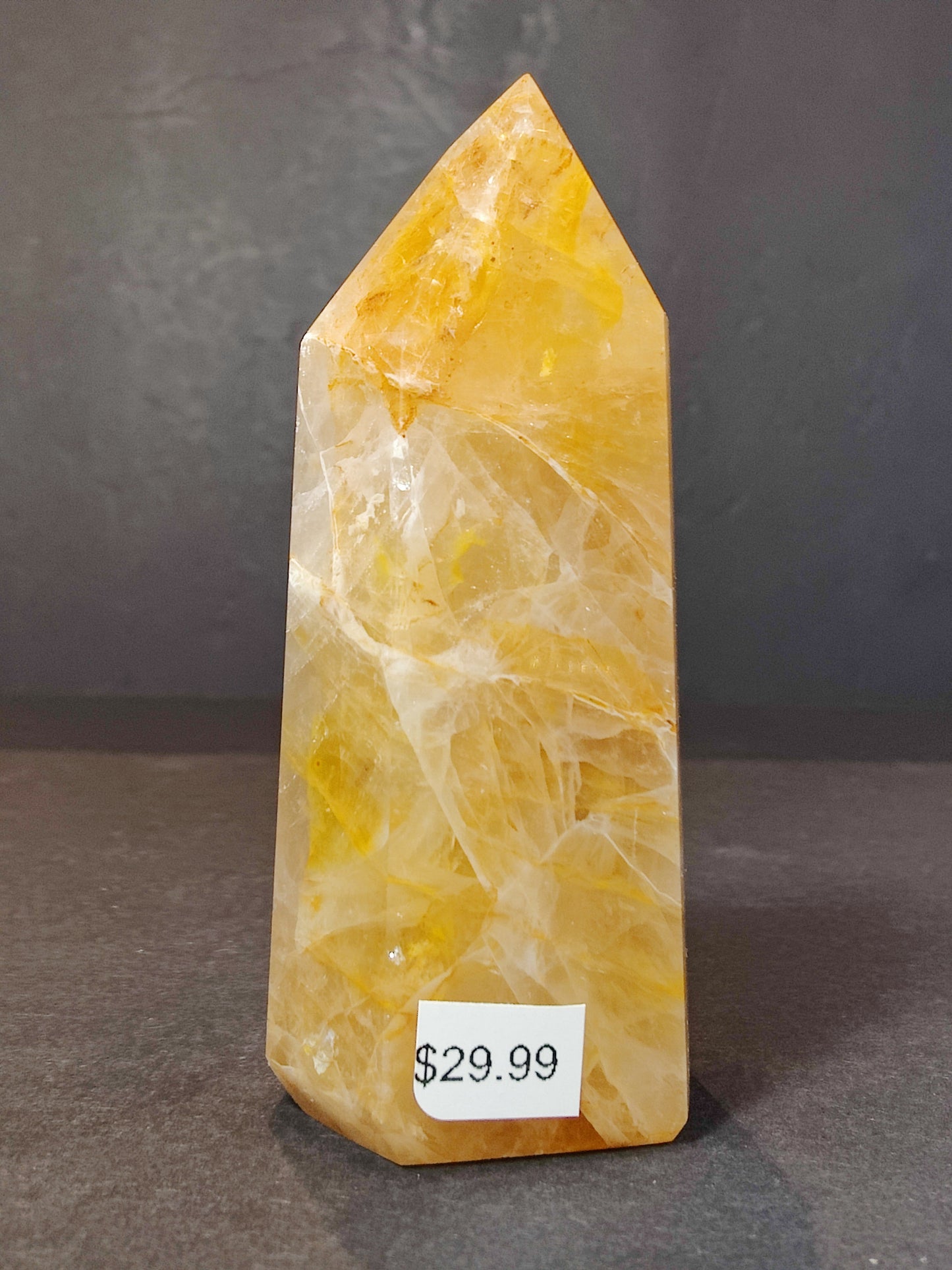 Detail of the polished surface of the Golden Healer Hematoid Quartz Obelisk Tower