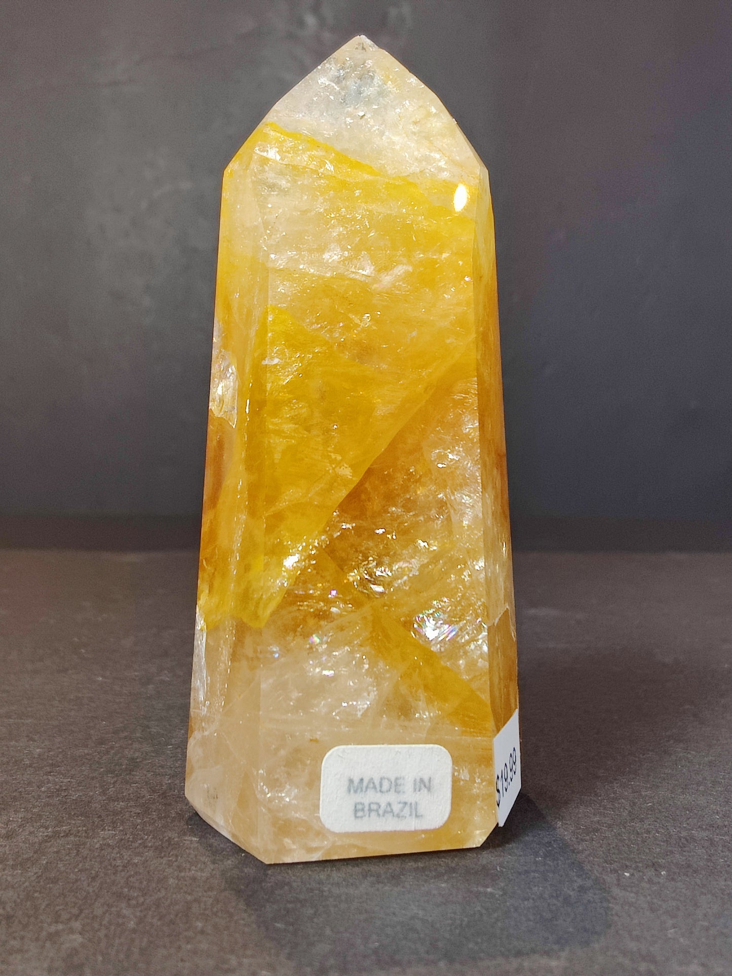 The Golden Healer Hematoid Quartz Obelisk Tower photographed against a plain backdrop for scale