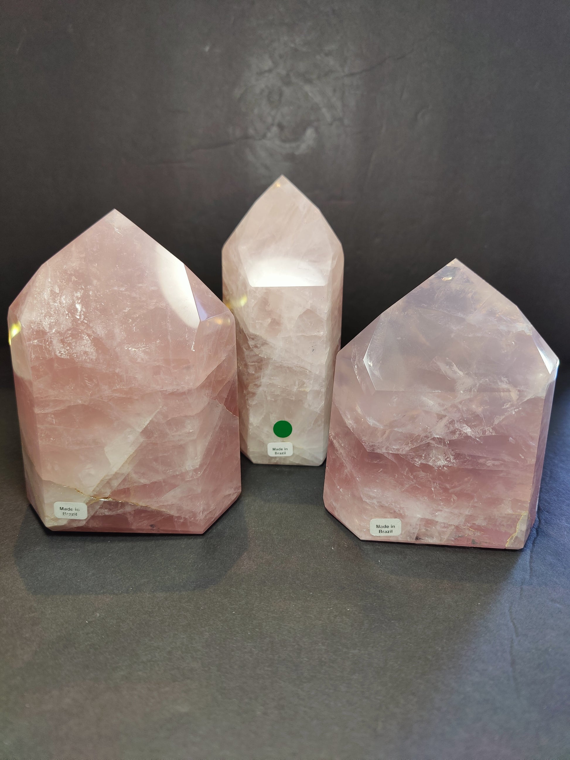 Polished rose quartz obelisk tower in soft translucent pink, standing upright