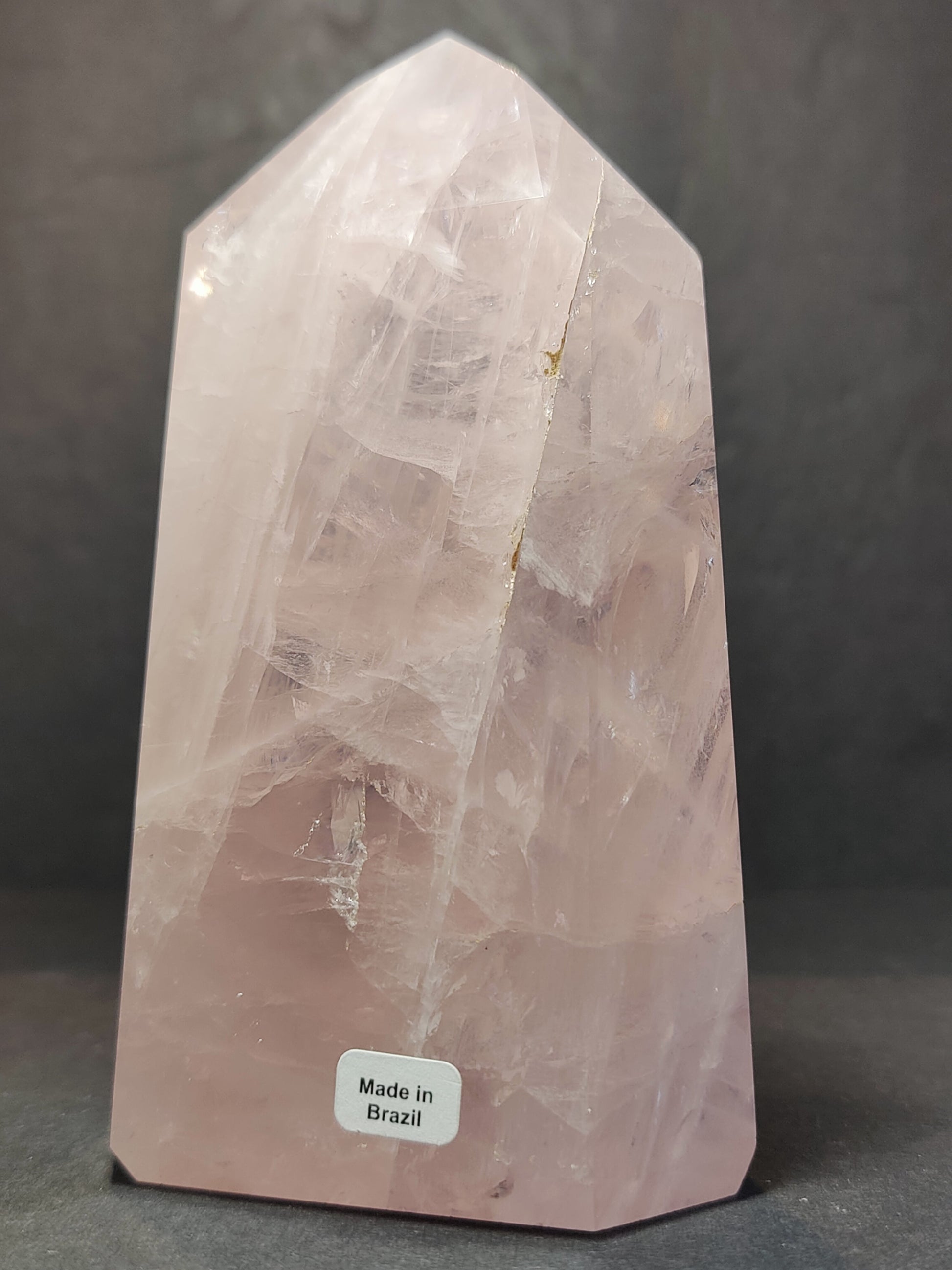 Polished rose quartz obelisk tower in soft translucent pink, standing upright — view 2