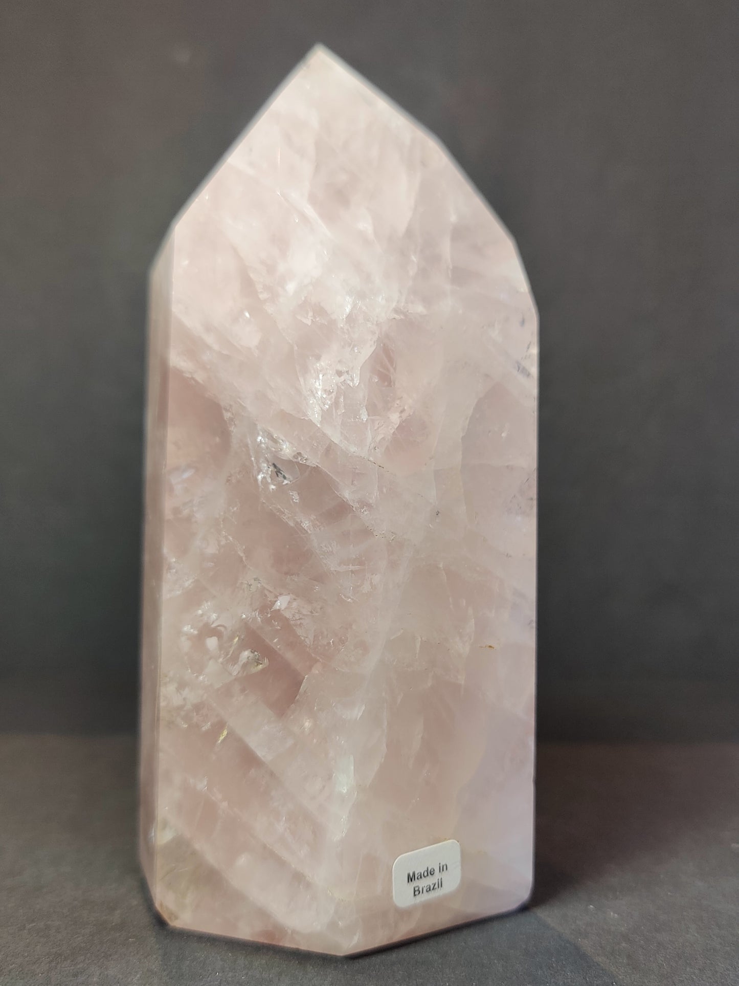 Polished rose quartz obelisk tower in soft translucent pink, standing upright — view 3