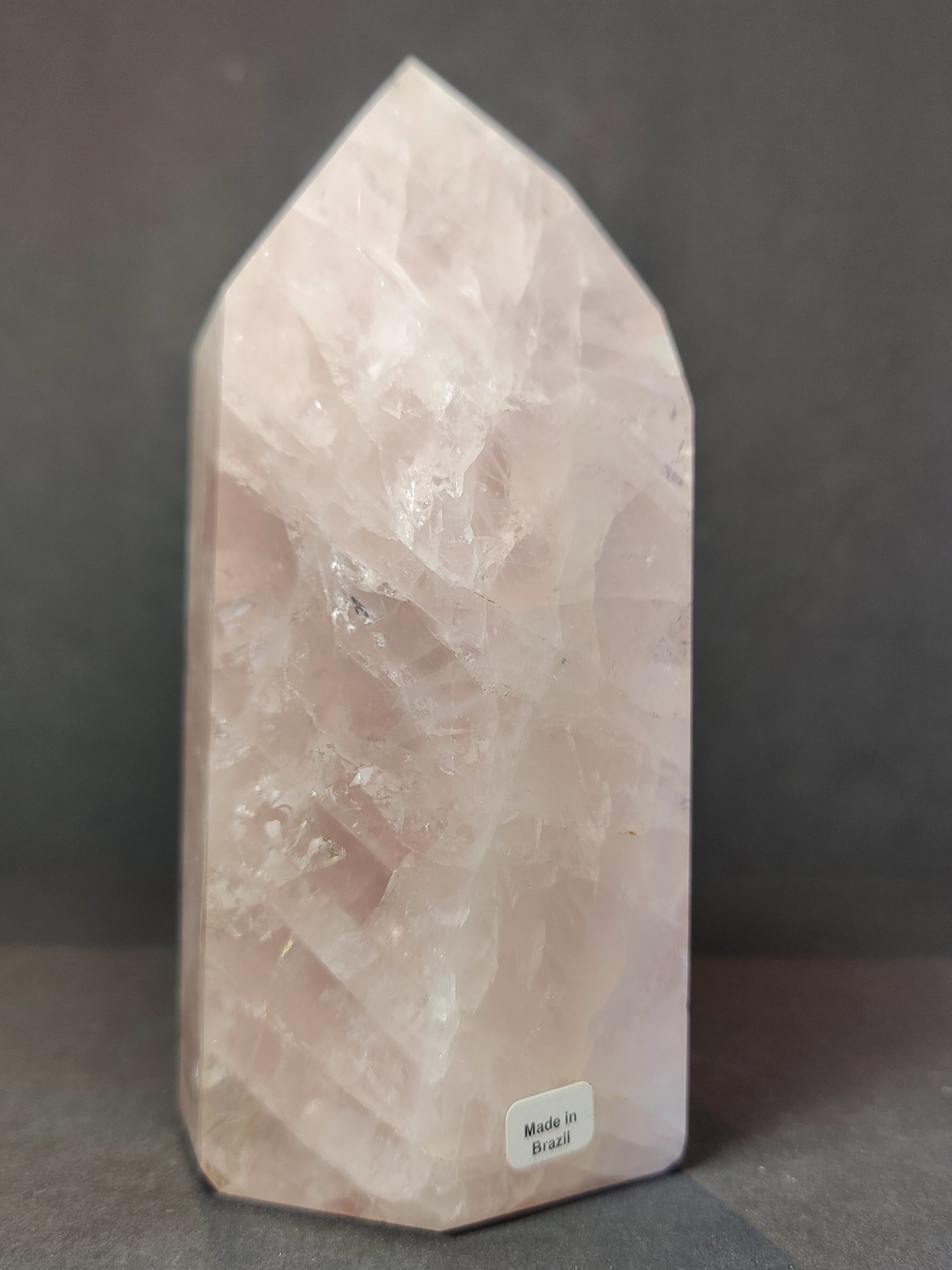 Polished rose quartz obelisk tower in soft translucent pink, standing upright — view 3