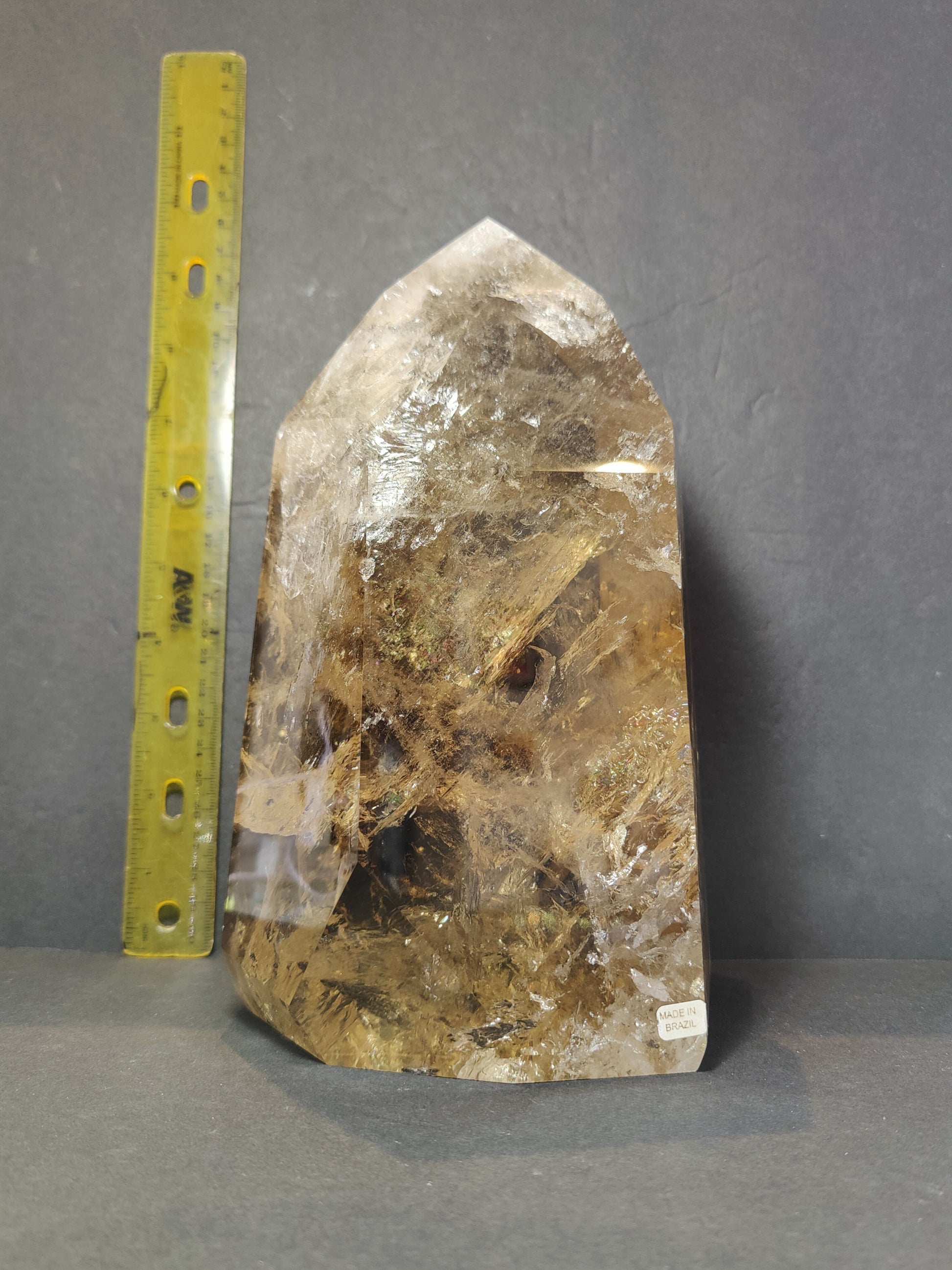 Side view of the polished Natural Citrine Polished Point 4.53 kg showing its colour and inclusions