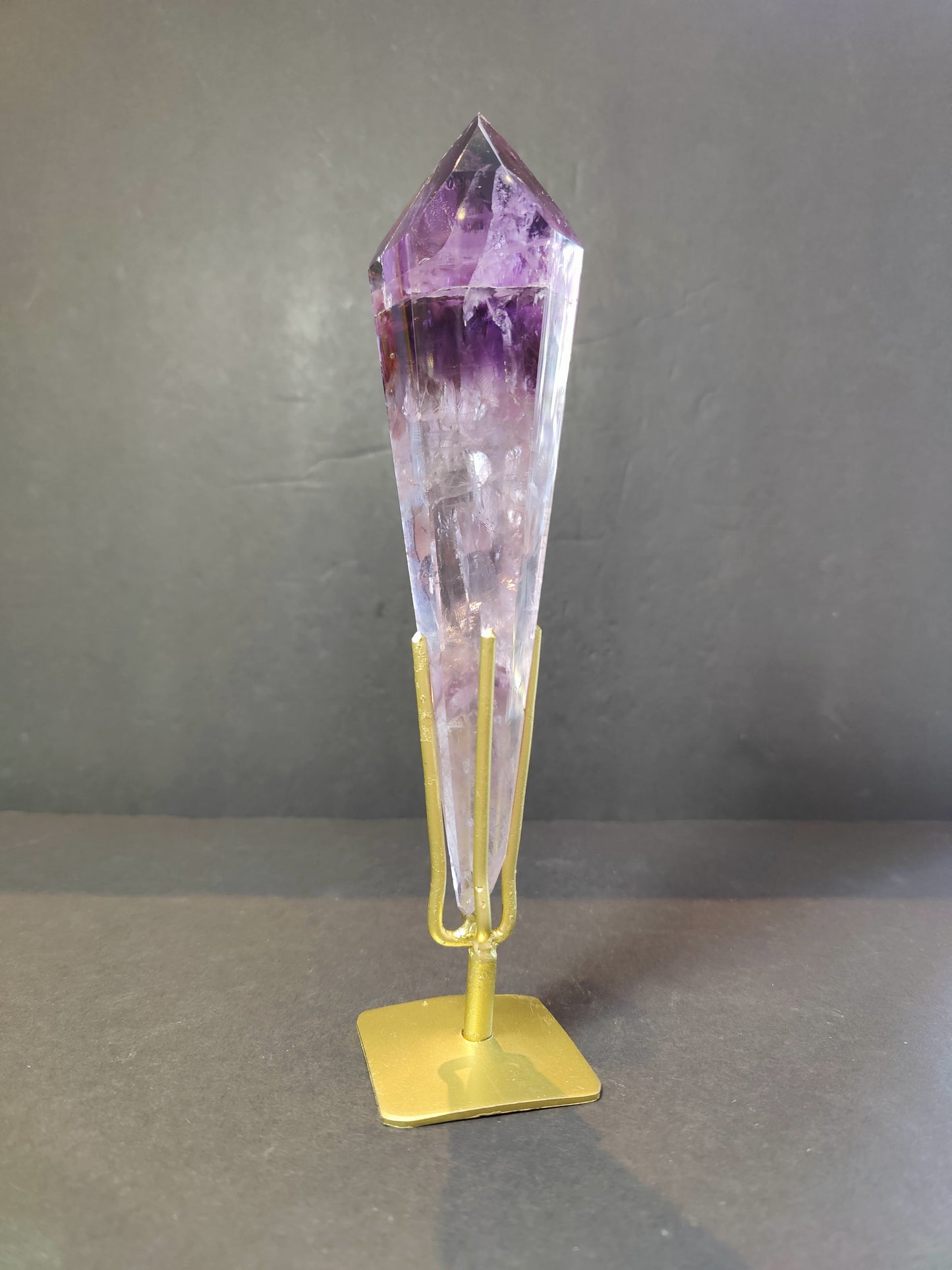 Three amethyst scepter wands of assorted sizes side by side