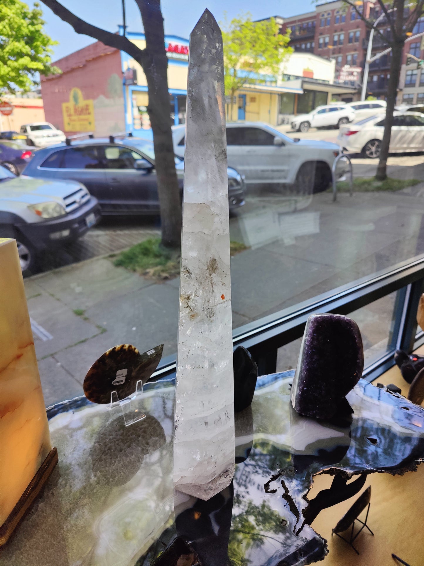 Tall polished clear quartz obelisk standing 20.5 inches, with natural internal veils — view 2