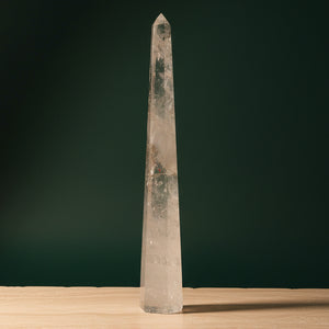 Tall polished clear quartz obelisk standing 20.5 inches, with natural internal veils