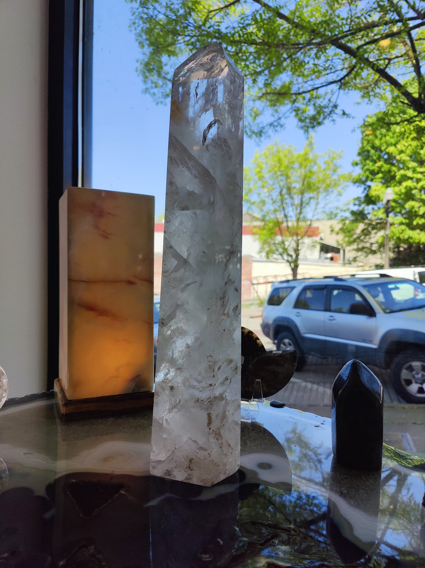 Clear quartz obelisk shown at an angle to reveal its full height