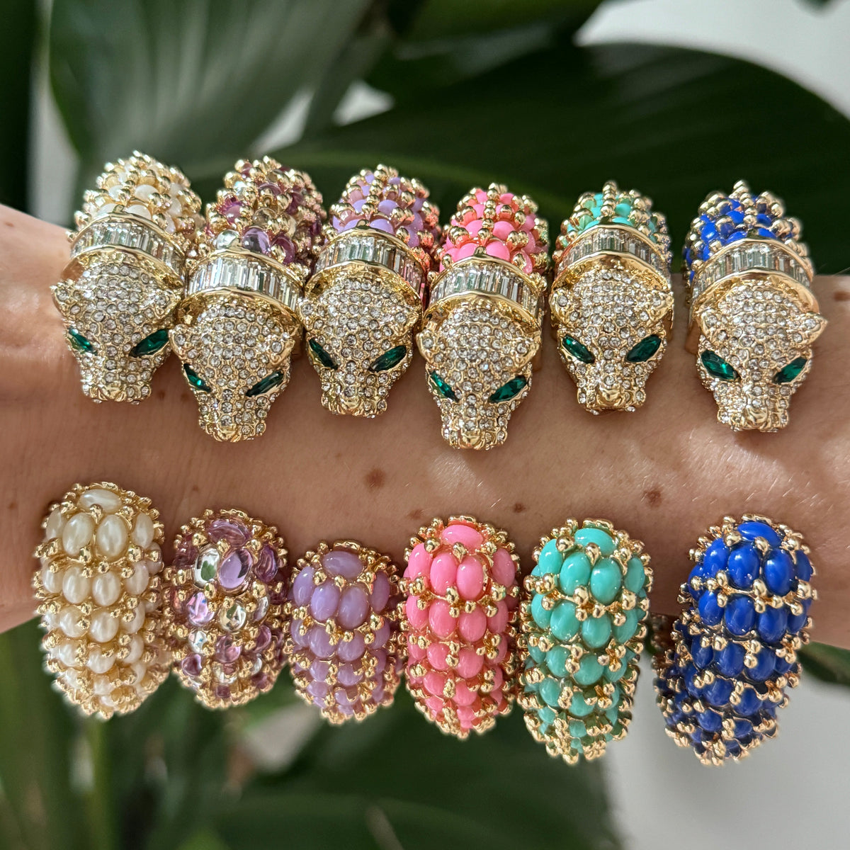 Six panther cuffs from the line photographed head-on against a leaf; this listing is the white one.