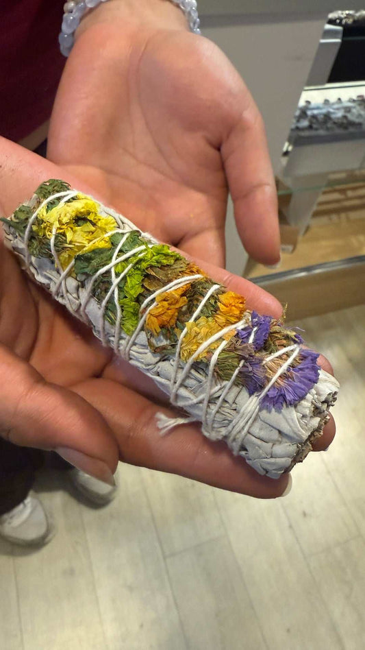 Four-inch white sage smudge stick bound with purple statice floral