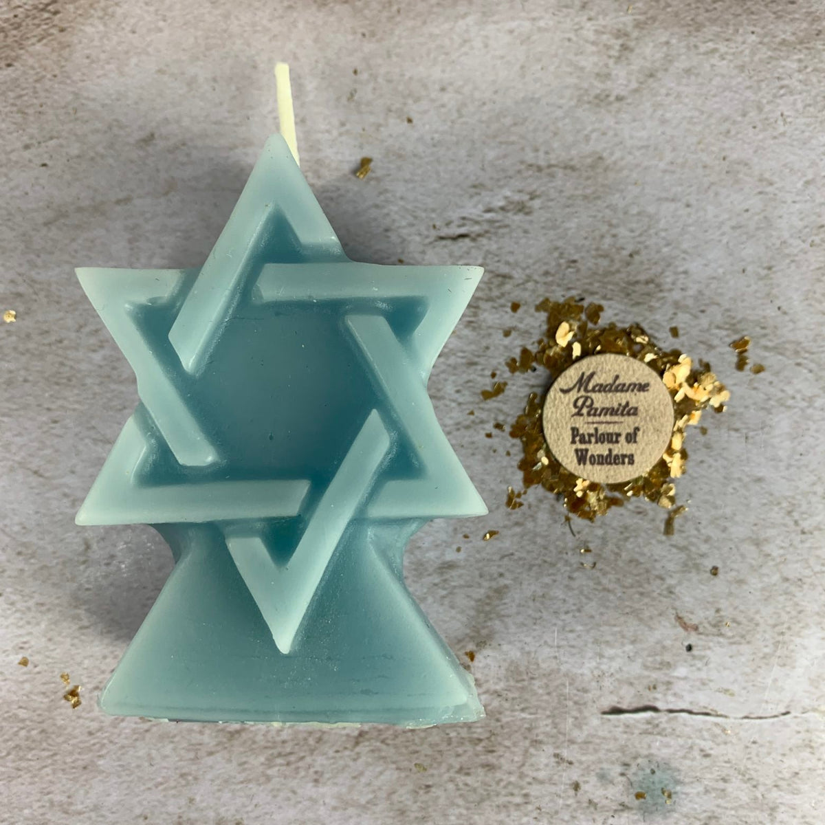 Teal blue beeswax Seal of Solomon hexagram candle with the two interlocked triangles clearly defined