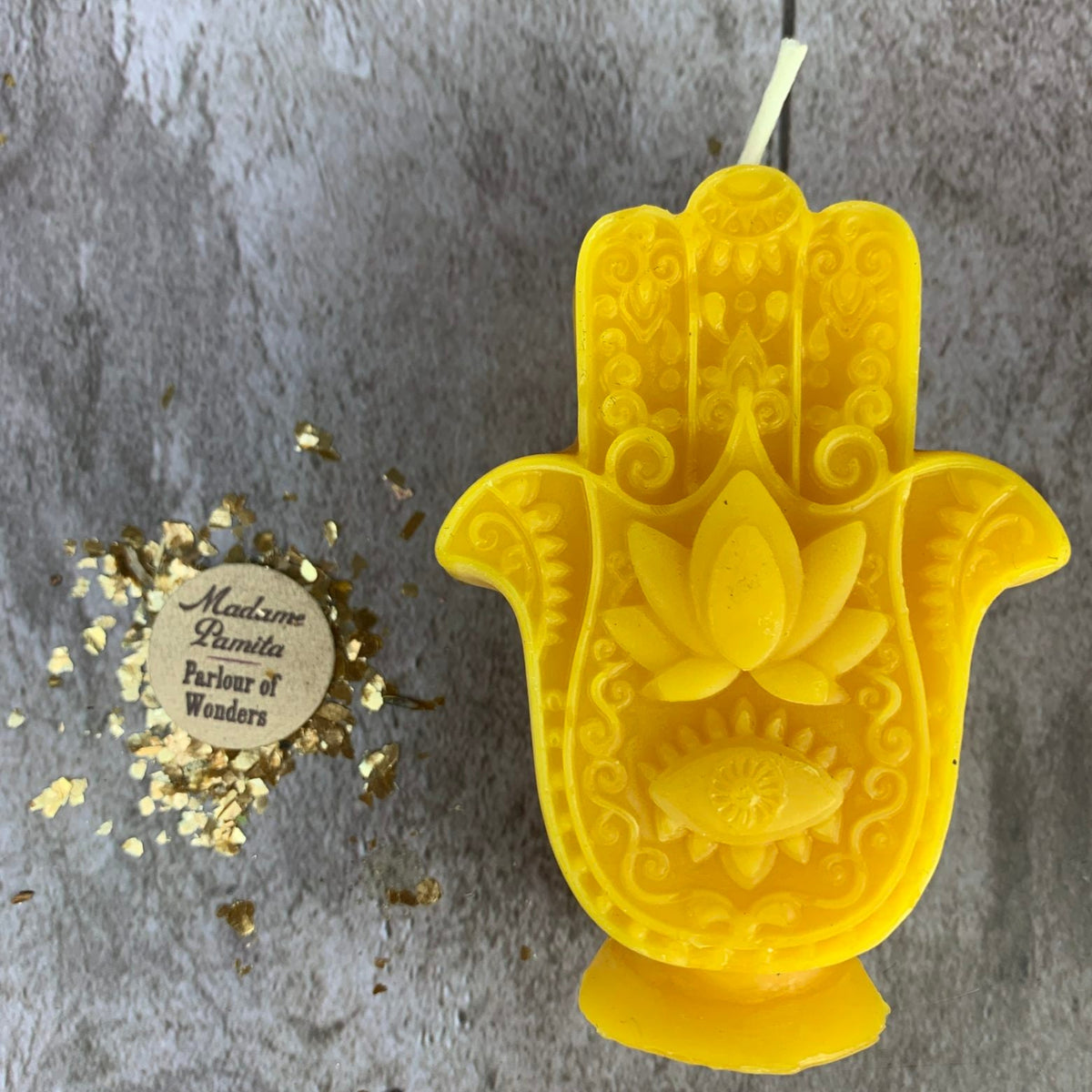 Yellow Hamsa candle, the brightest of the range, with a long white cotton wick.