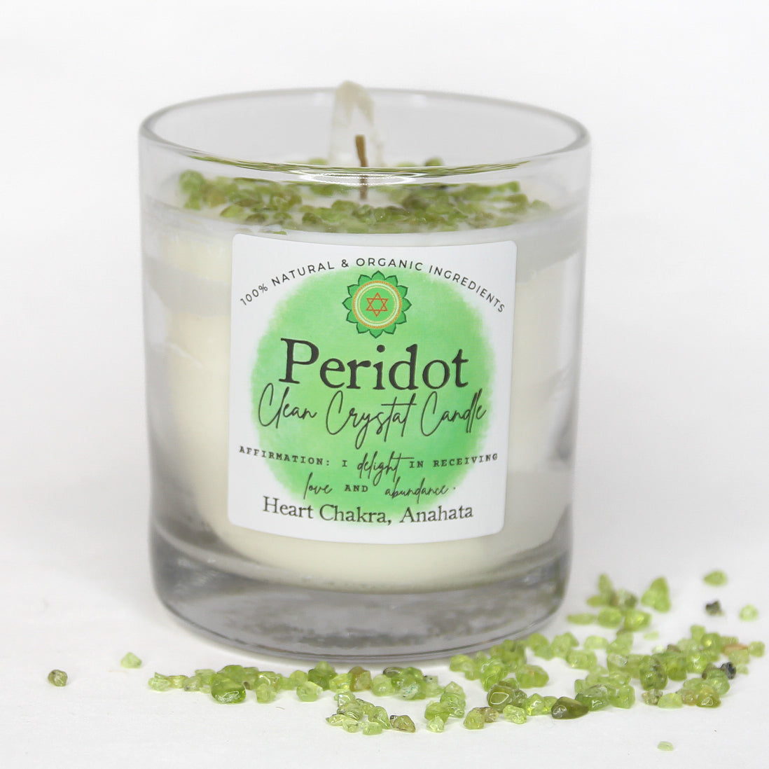 Peridot Clean Crystal Candle in a clear lead-free glass tumbler, topped with green peridot chips and a clear quartz point — product photo 6