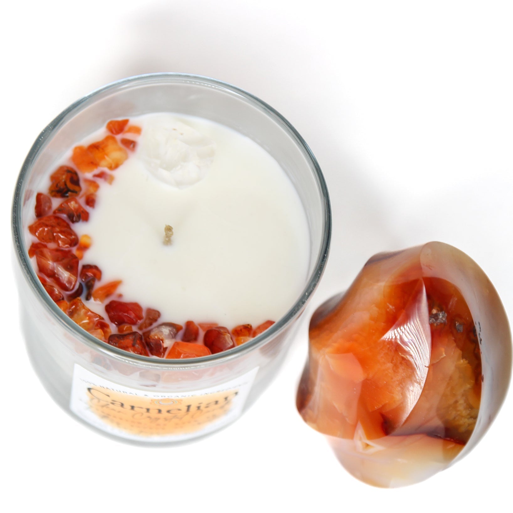 The Carnelian chakra candle with its label and crystal detail