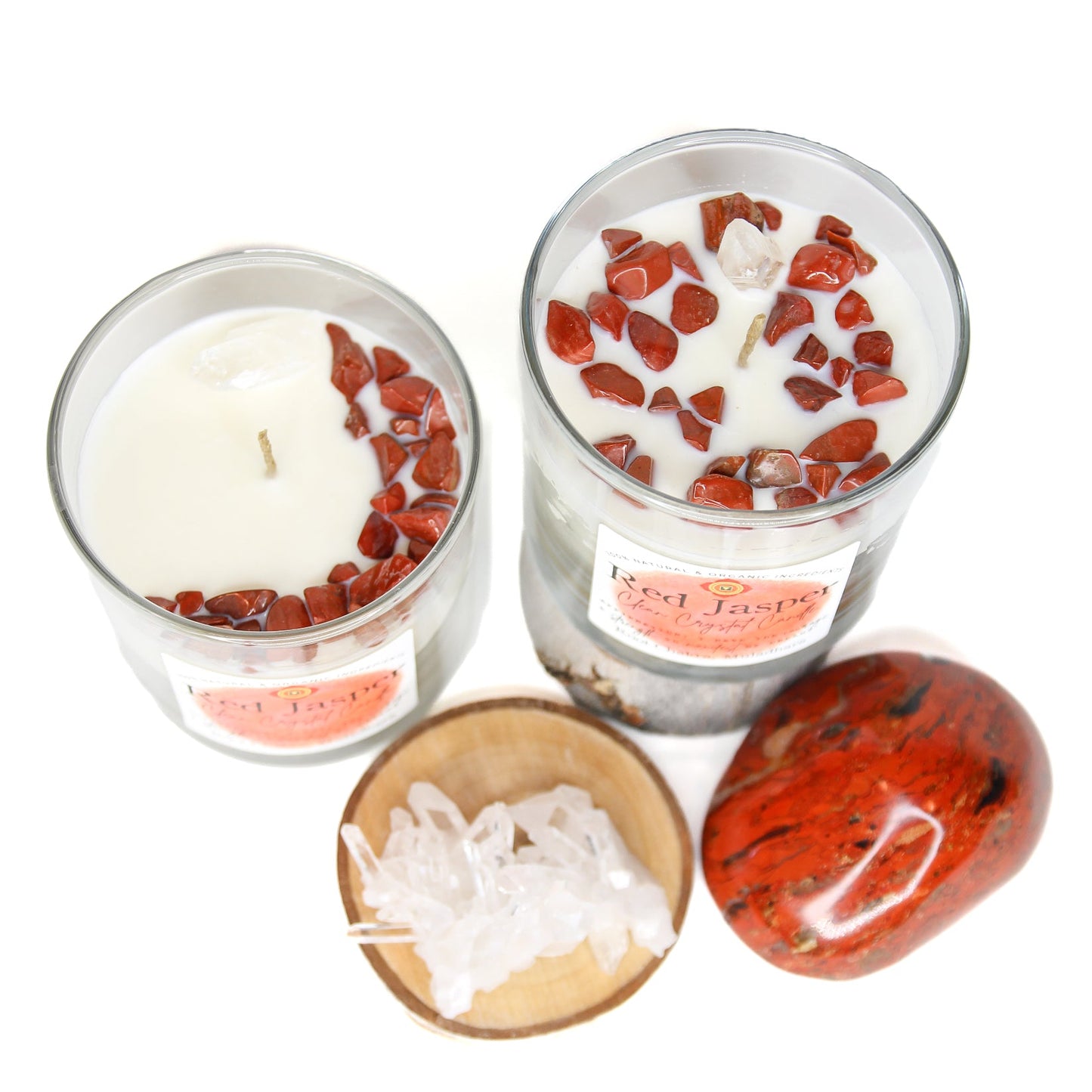 The Red Jasper chakra candle lit on a dark surface