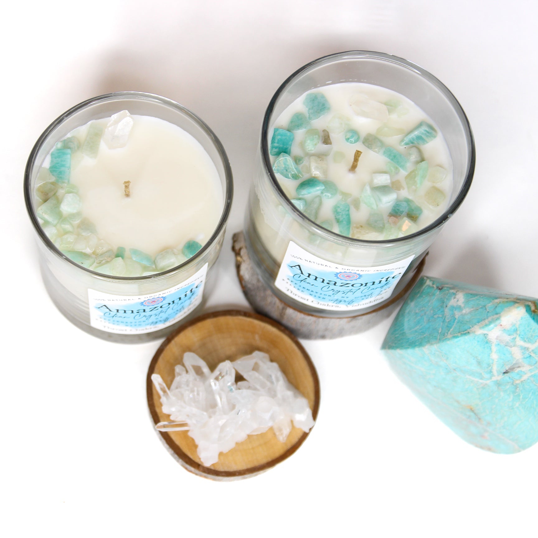 The Amazonite chakra candle lit on a dark surface