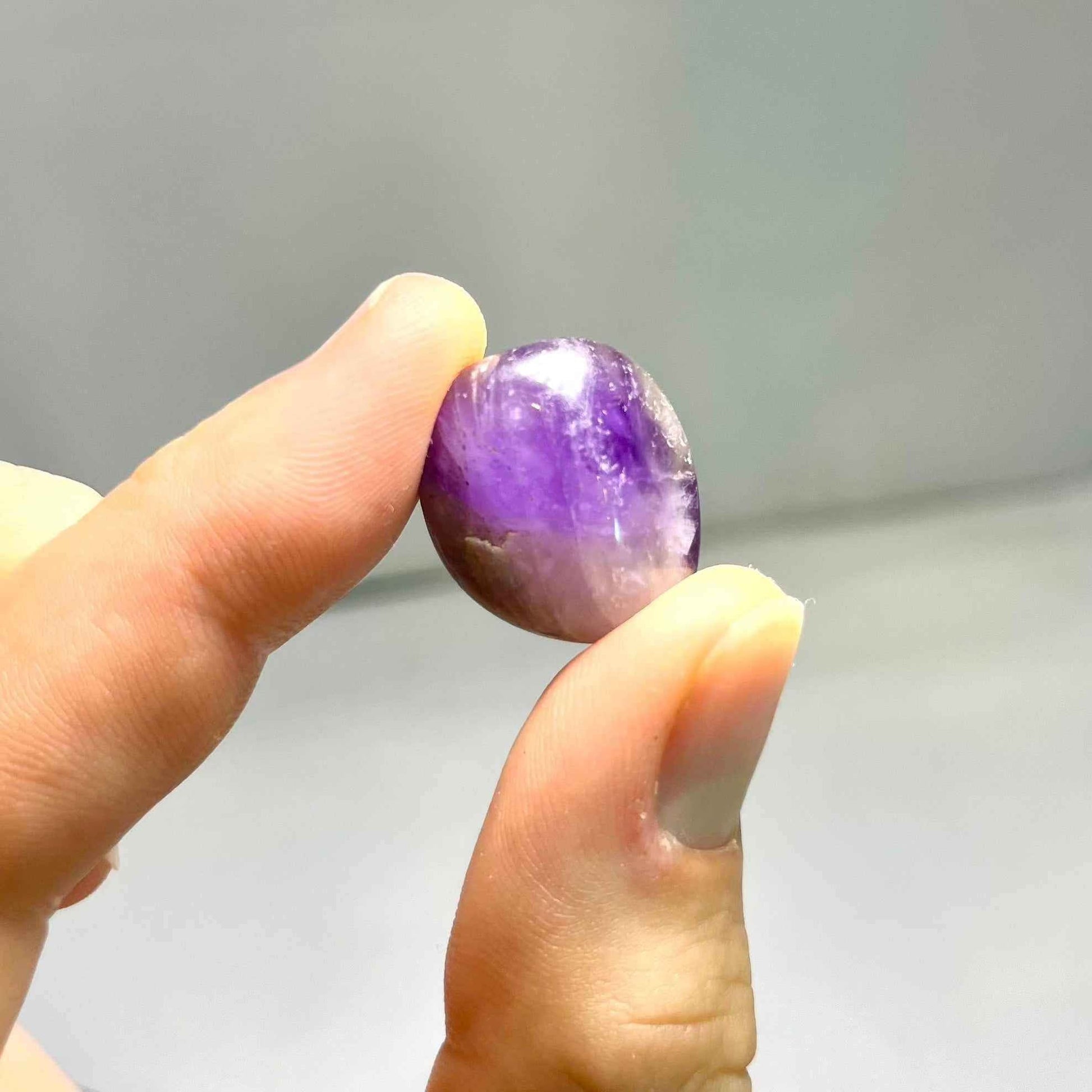 Tumbled amethyst stones displaying natural variation in purple tone