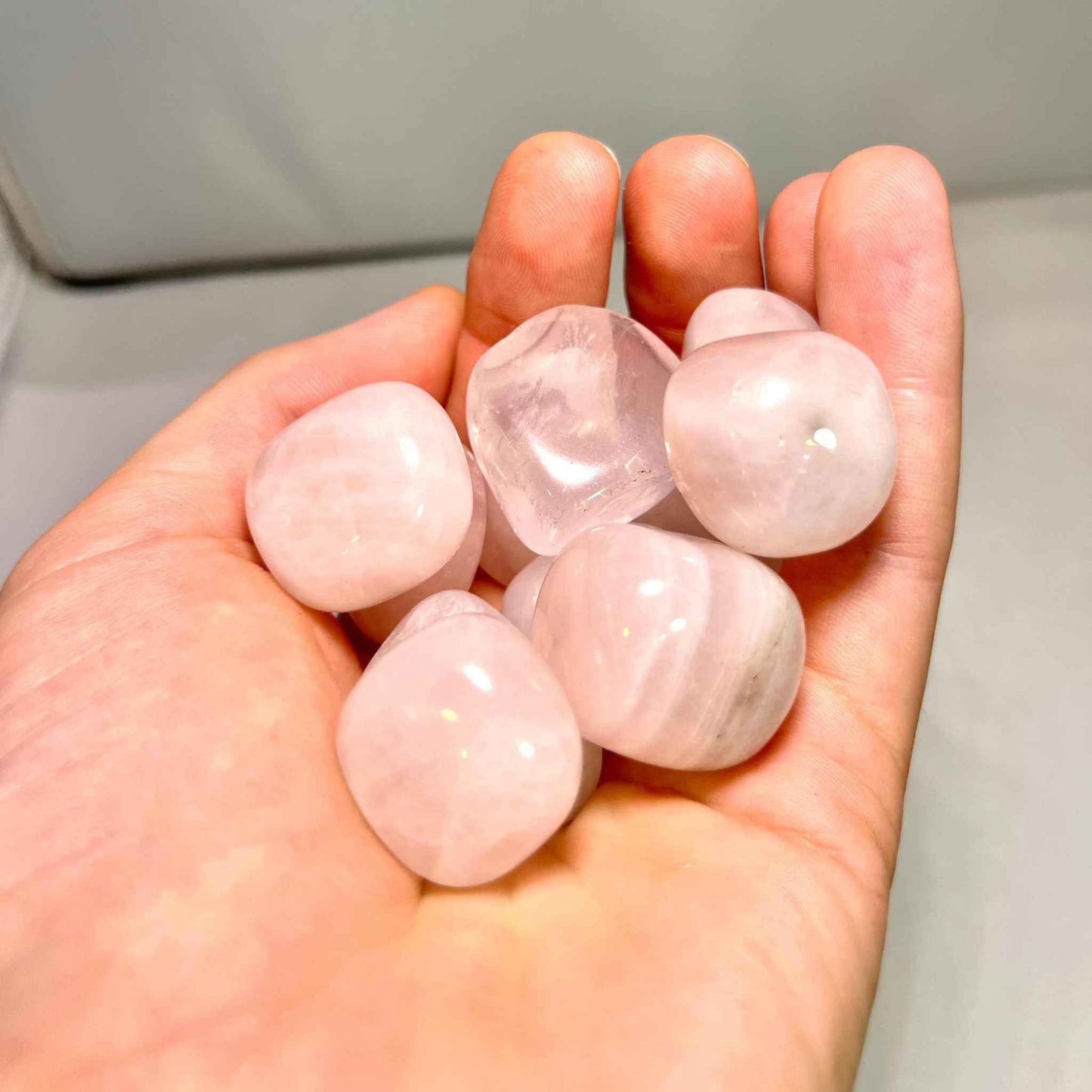Soft translucent pink rose quartz tumbled pocket stone, detail view