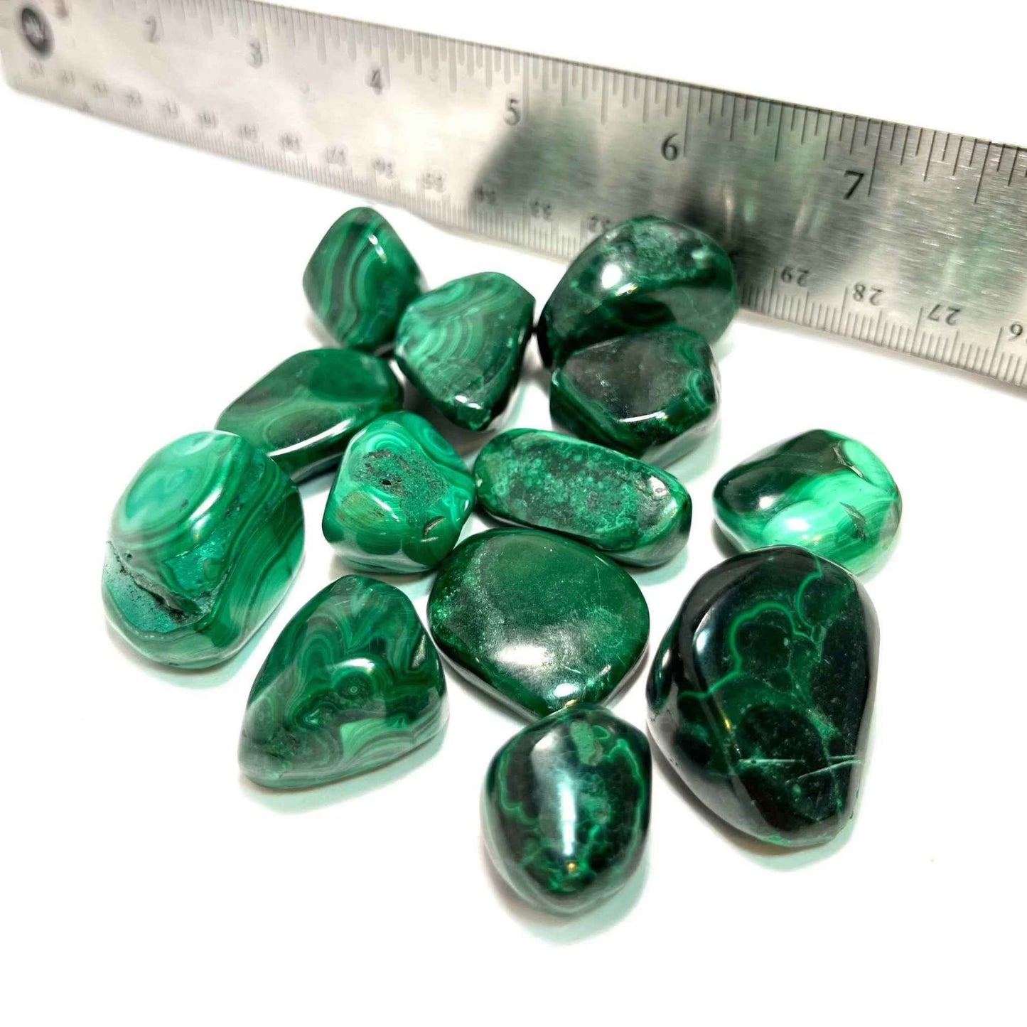 Polished green Malachite tumbled stone shown from a second angle