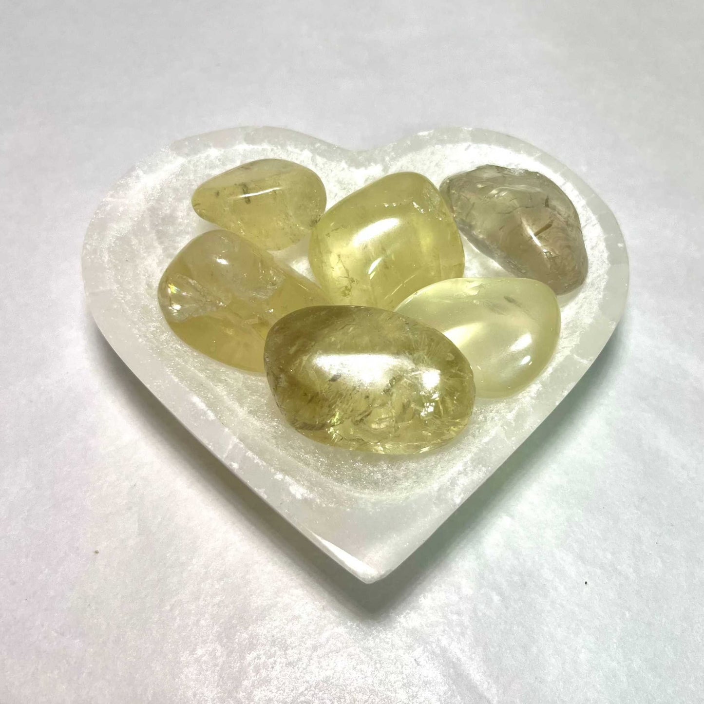 Pale golden natural citrine tumbled stone with warm translucency, additional view