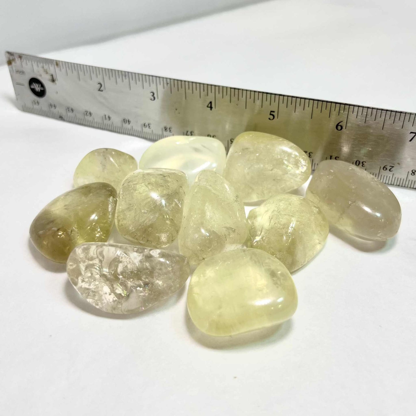 Pale golden natural citrine tumbled stone with warm translucency, alternate view