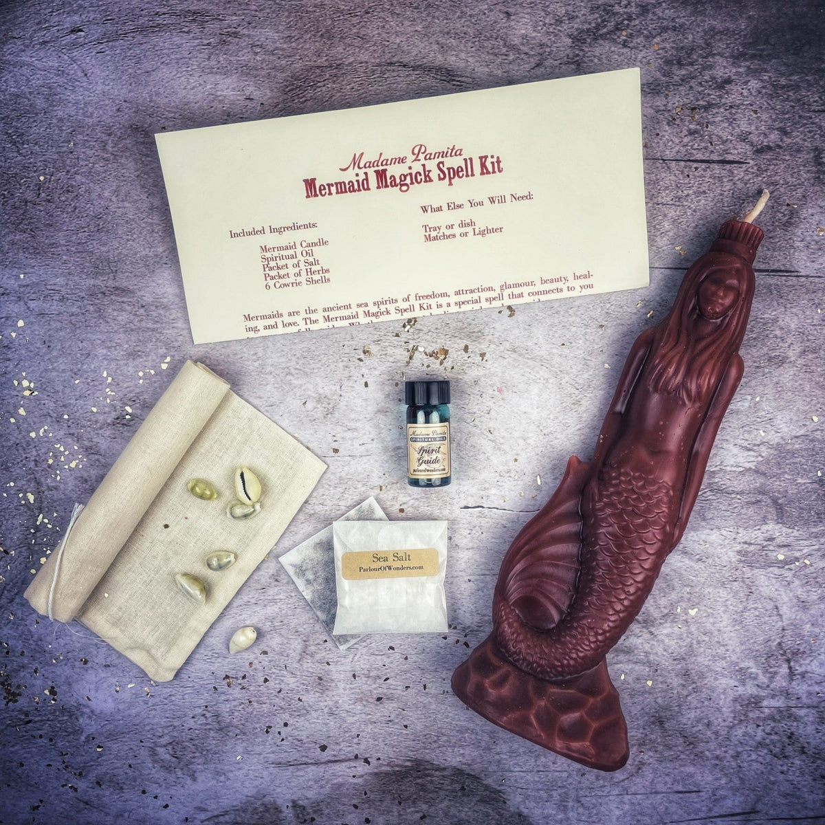 Maroon-brown mermaid candle with the kit, hair and scales sharply molded.