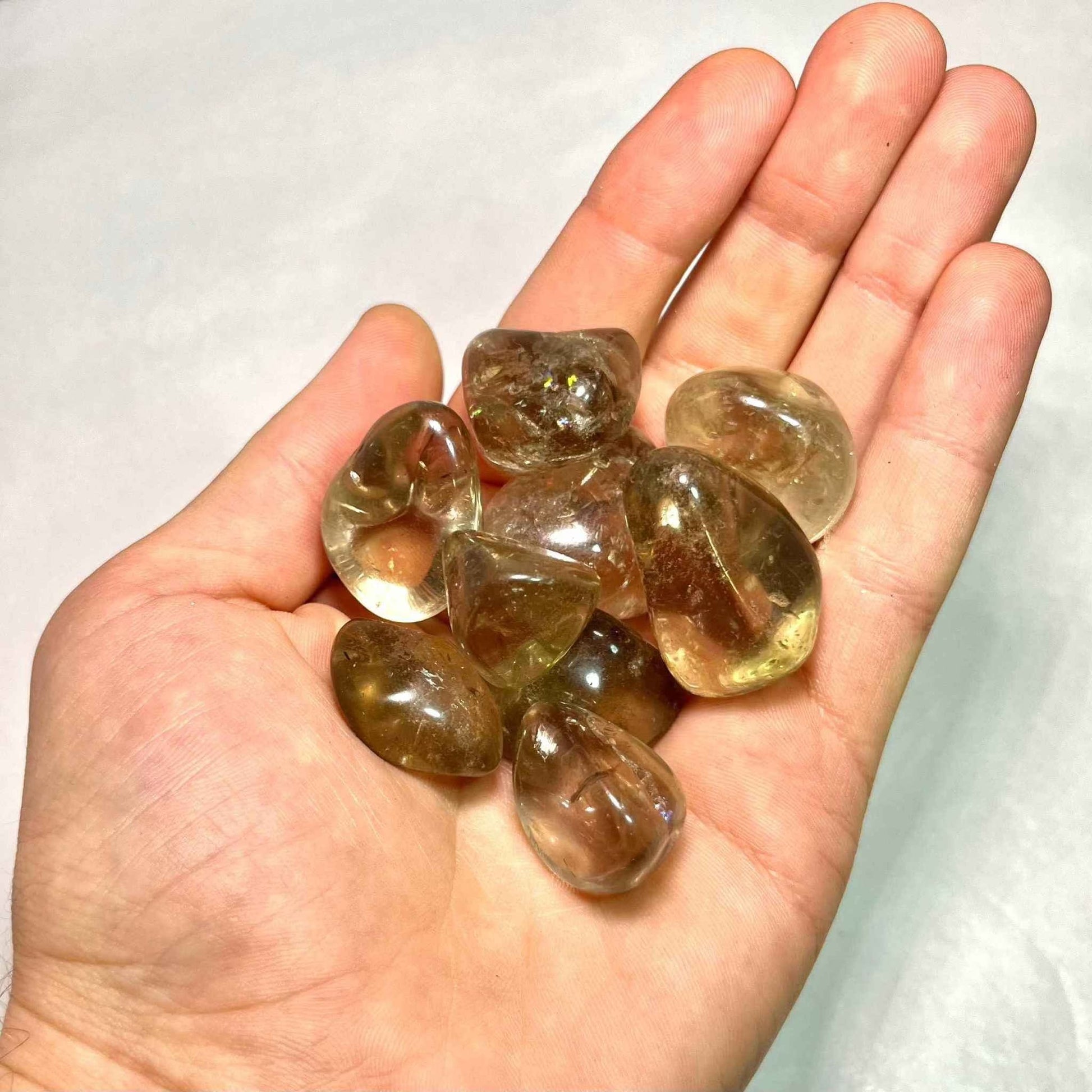 Translucent smoky quartz tumbled pocket stone in soft brown-grey, detail view