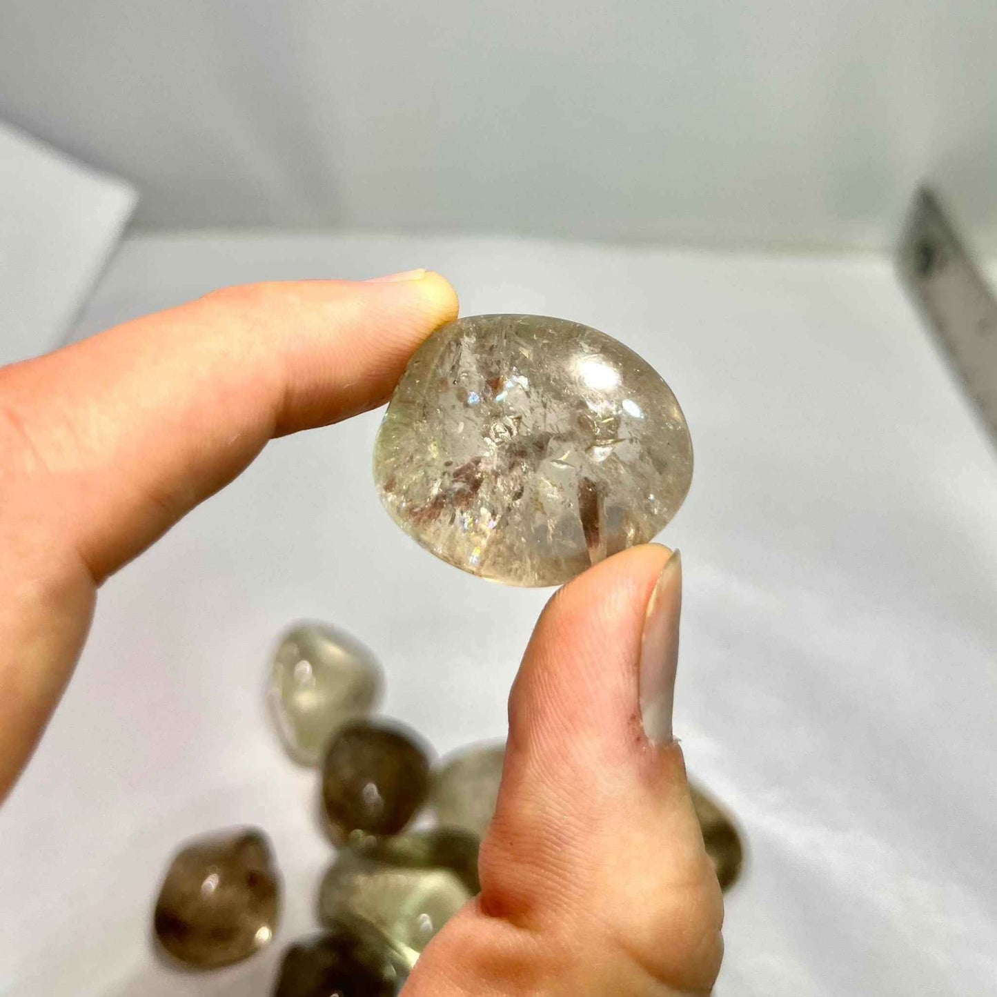 Translucent smoky quartz tumbled pocket stone in soft brown-grey, further view