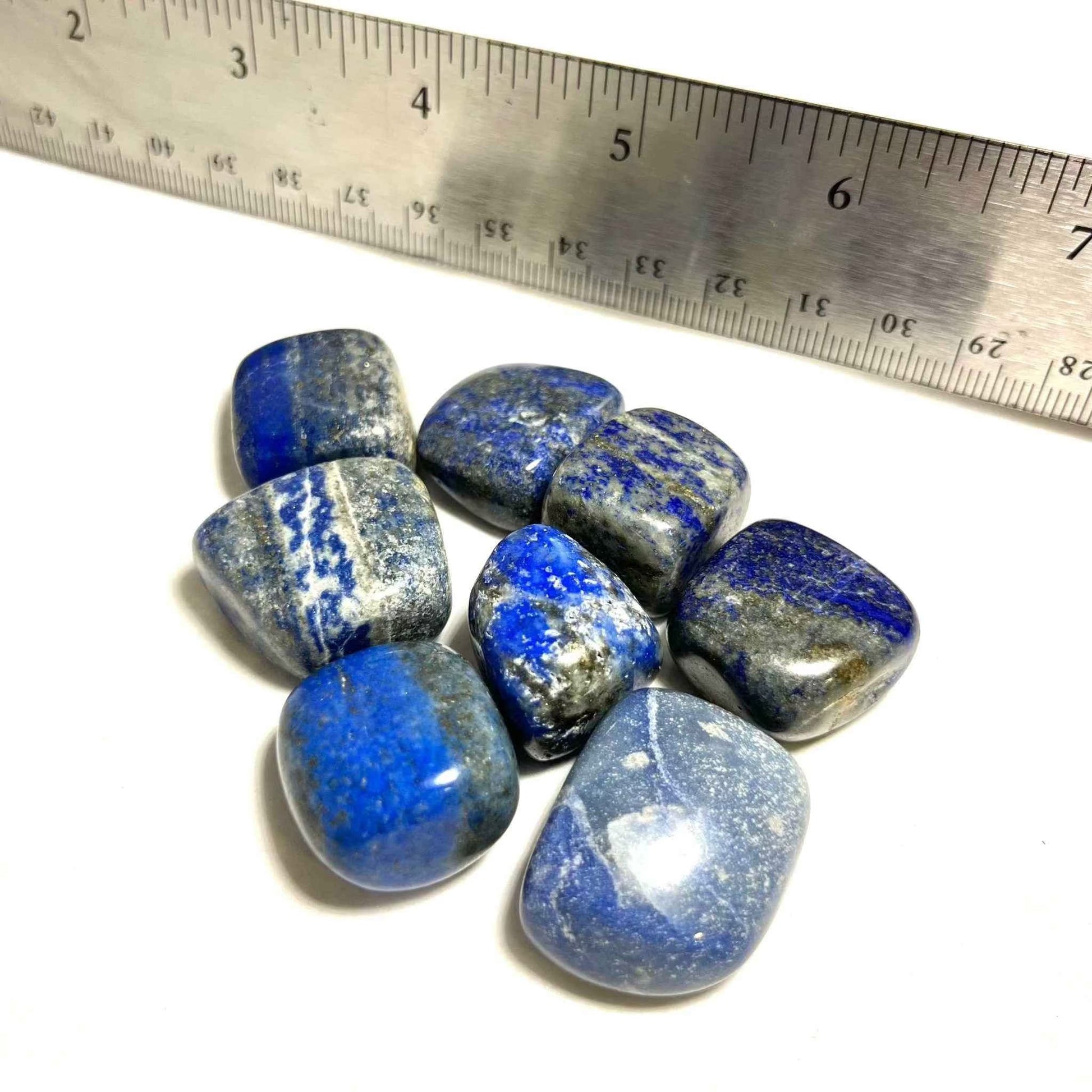 A lapis lazuli pocket stone shown from another angle, its blue surface marked with pale veining.