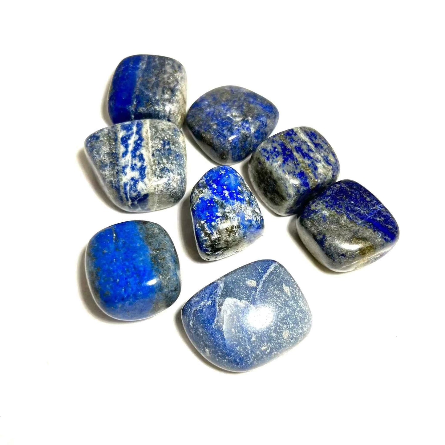 A tumbled lapis lazuli pocket stone in deep royal blue with flecks of gold-colored pyrite.