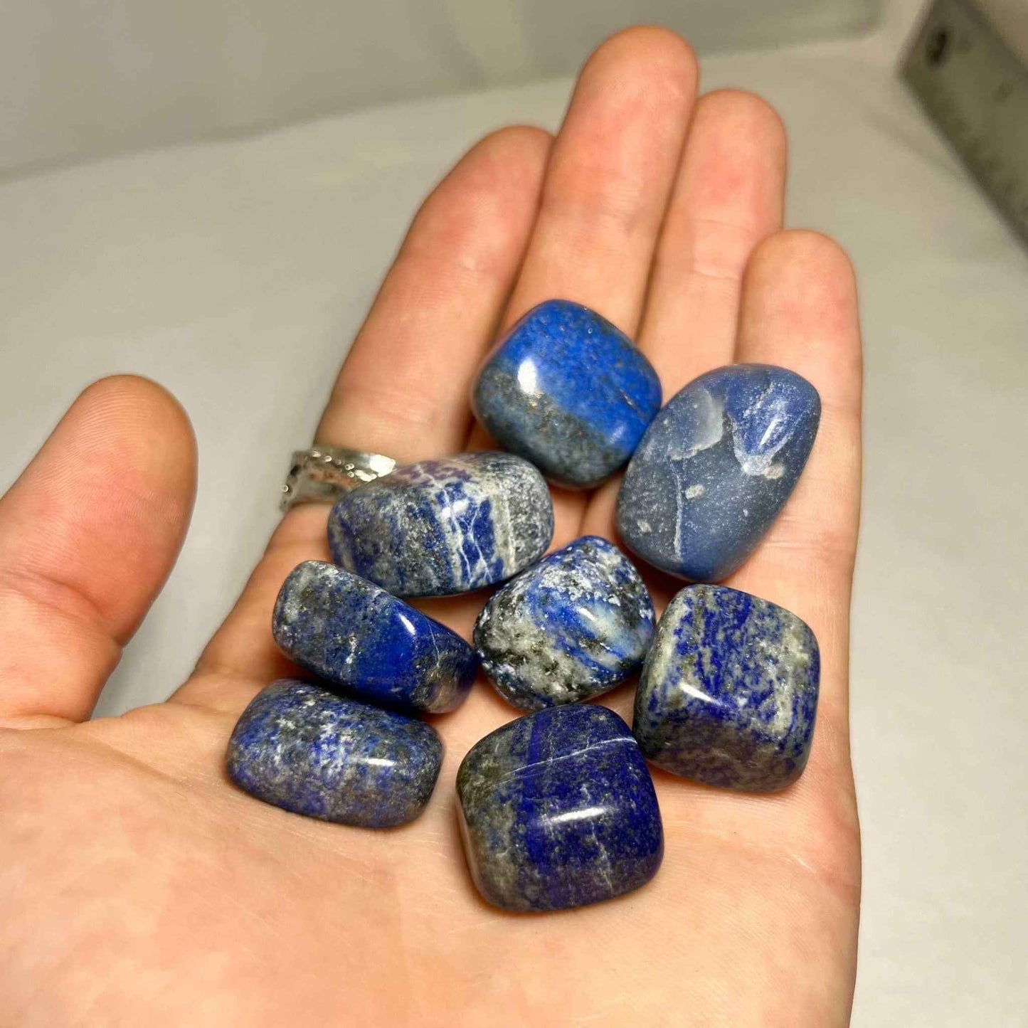 Close view of a polished lapis lazuli stone showing its rich blue color.