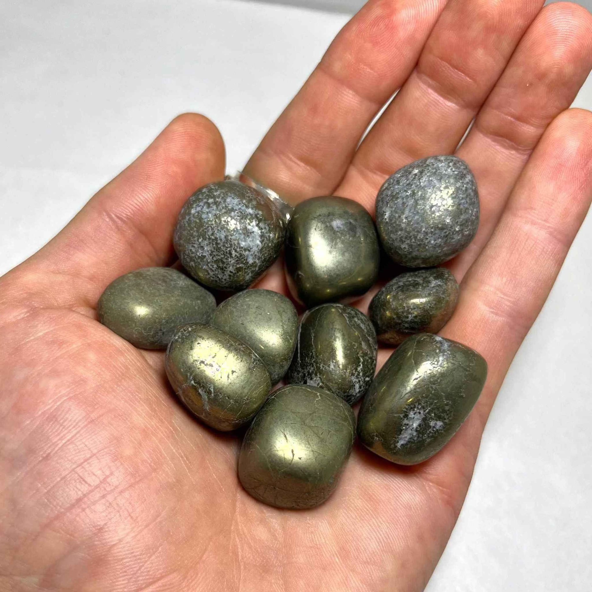 Close view of the metallic patterning on a tumbled Pyrite stone