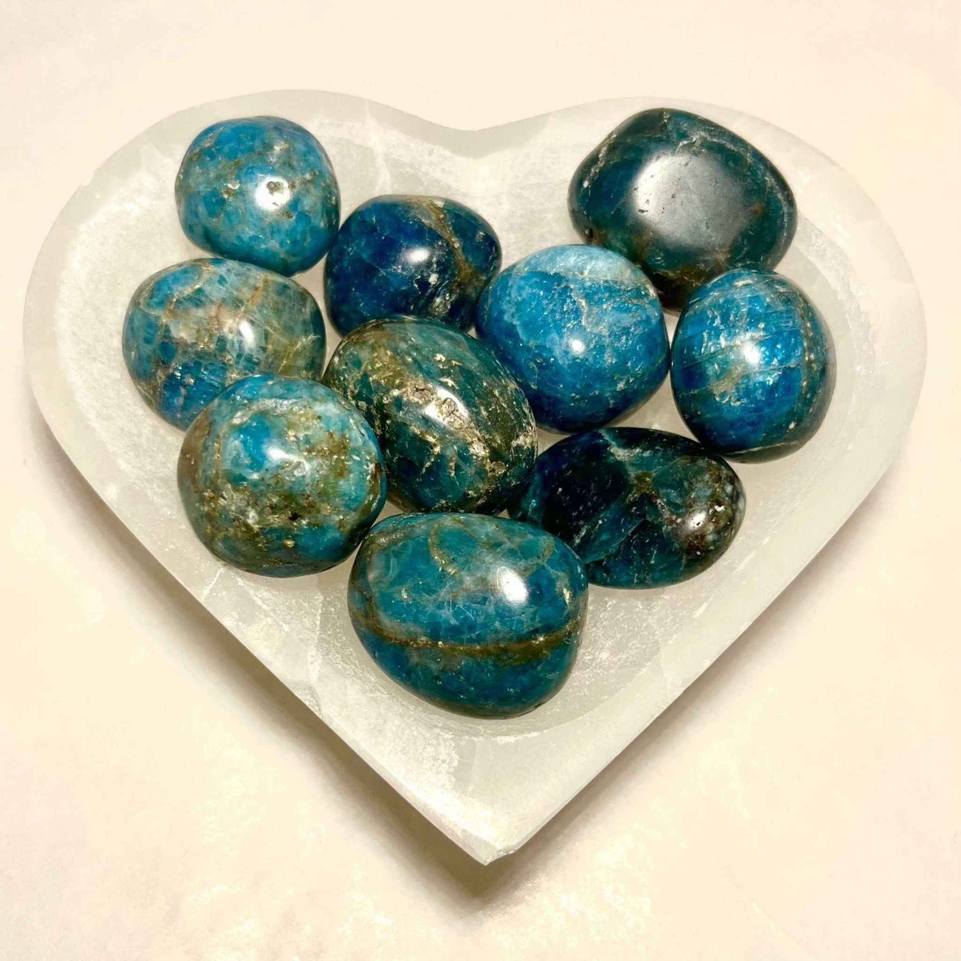 Smooth blue apatite stone on a plain background