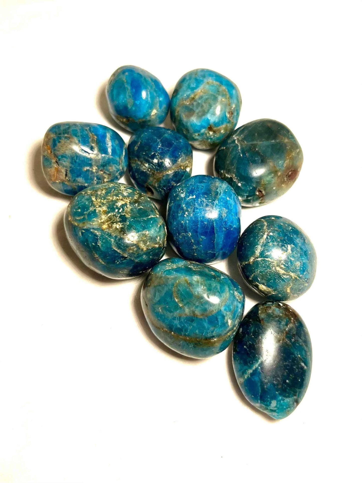 Polished blue apatite tumbled stone with mottled teal-blue coloring