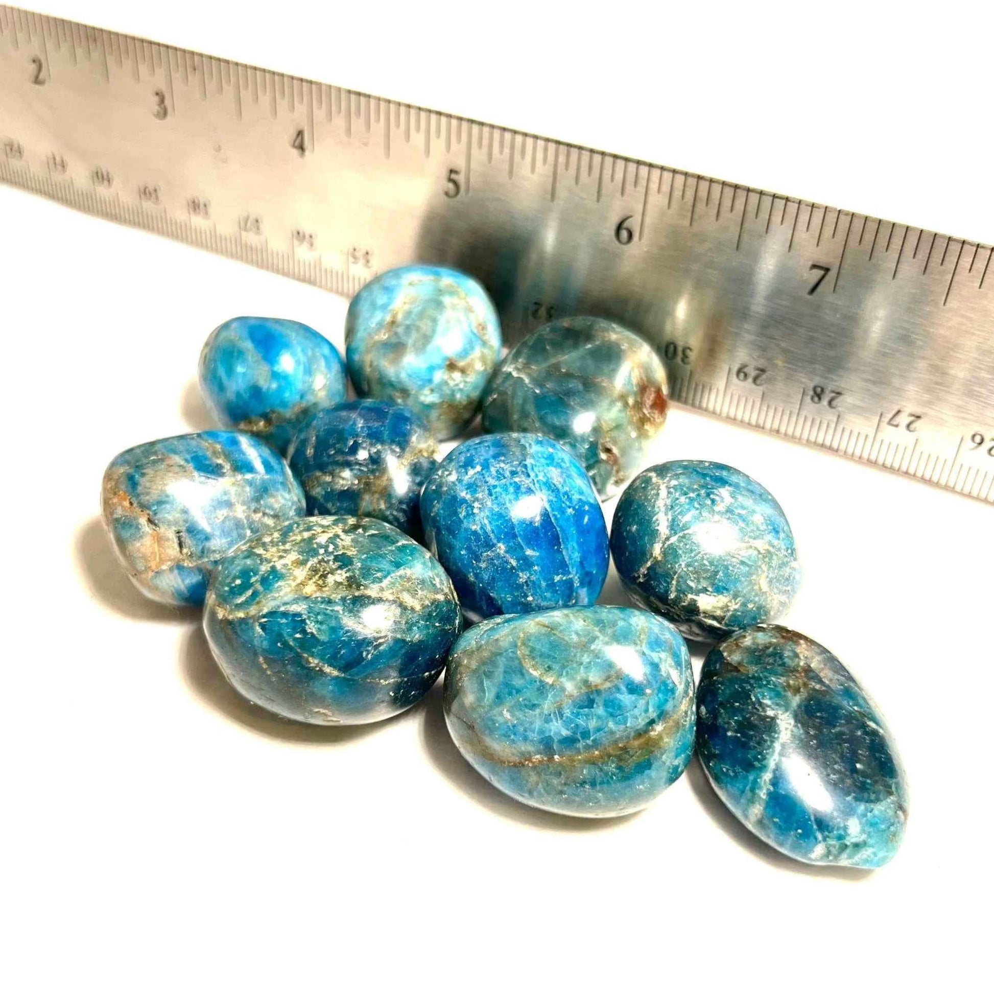 Blue apatite tumbled stone showing its glassy surface