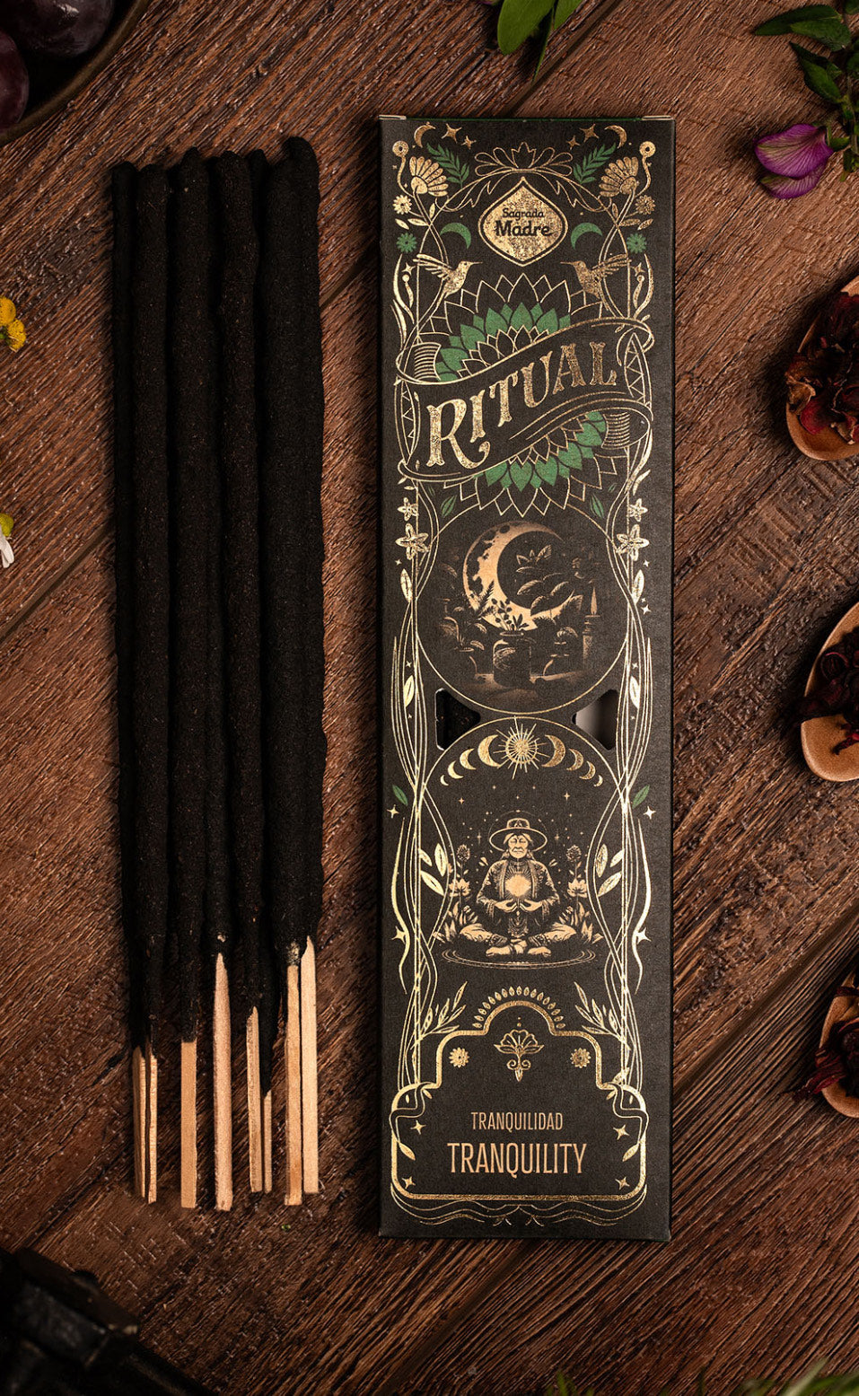 Tranquility Ritual incense sticks beside the black and gold Ritual box on dark wood