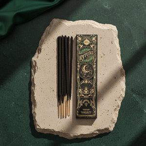 Tranquility Ritual incense sticks beside the black and gold Ritual box on dark wood