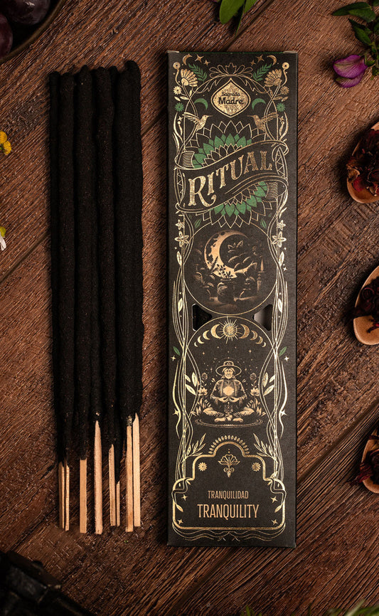 Tranquility Ritual incense sticks beside the black and gold Ritual box on dark wood