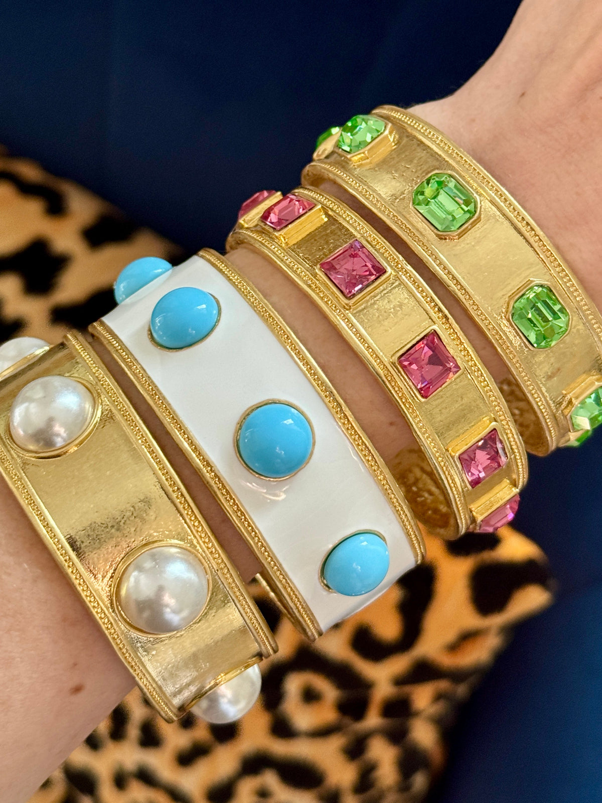 Four bangles from the line stacked on a wrist — pearl, white with turquoise glass, pink and green; this listing is the white enamel bangle with turquoise glass.
