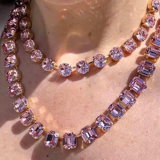 Two pink crystal necklaces worn layered, a round-stone strand above and an emerald-cut strand below; this listing is the emerald-cut necklace.
