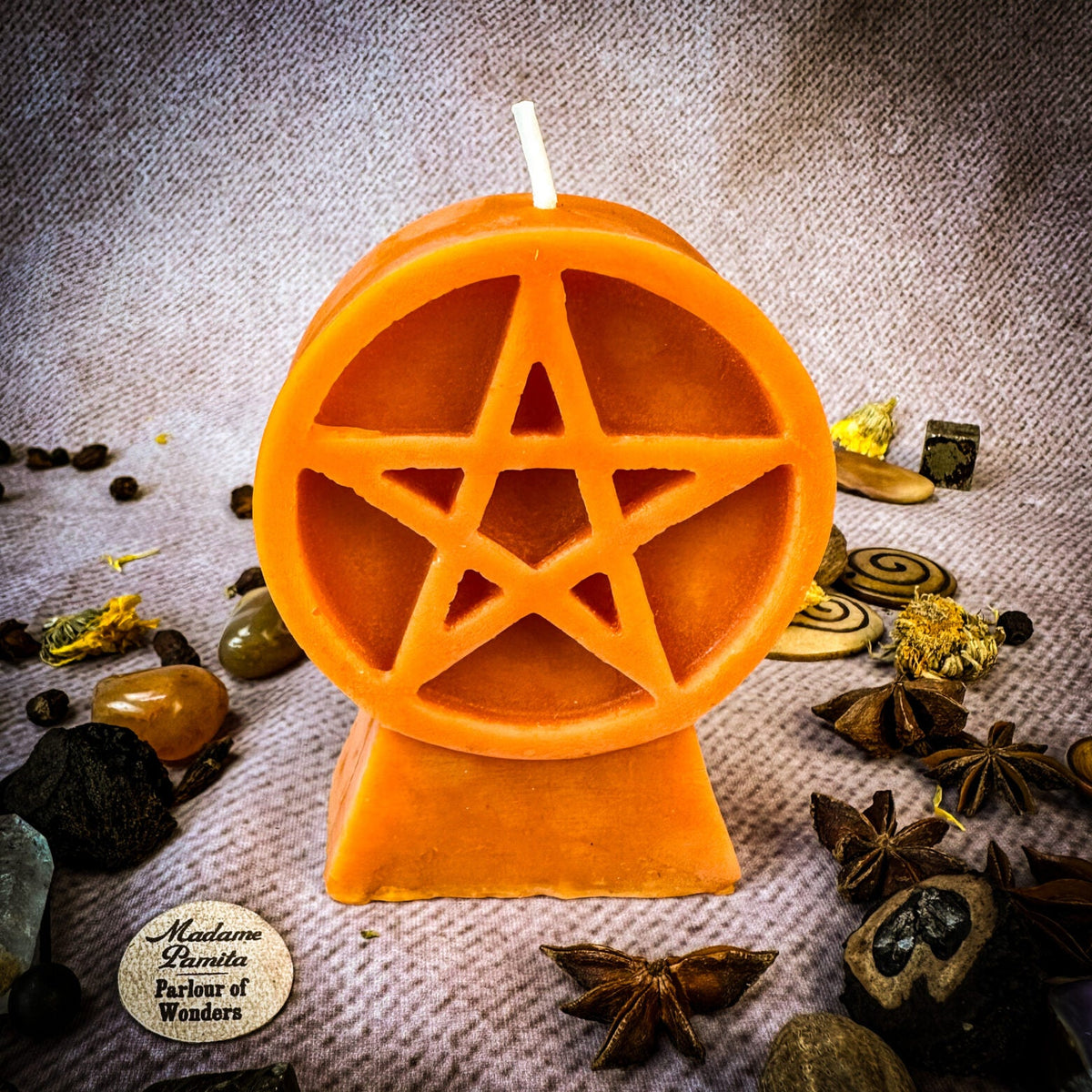 Pentacle of Protection beeswax candle in orange with herbs and botanicals