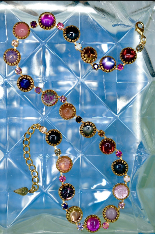 A gold-finish layering choker of multicolored vintage glass stones strung between clear crystals.