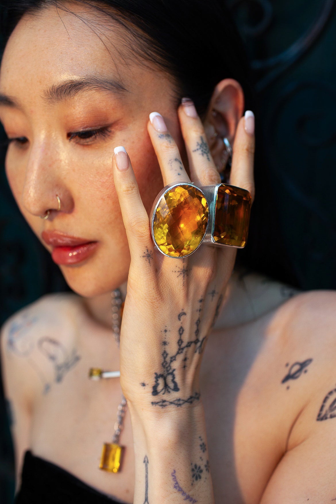 Oval Colossus Ring in Golden — oversized faceted golden yellow glass oval in a tall setting on a thick oxidized silver band — view 2